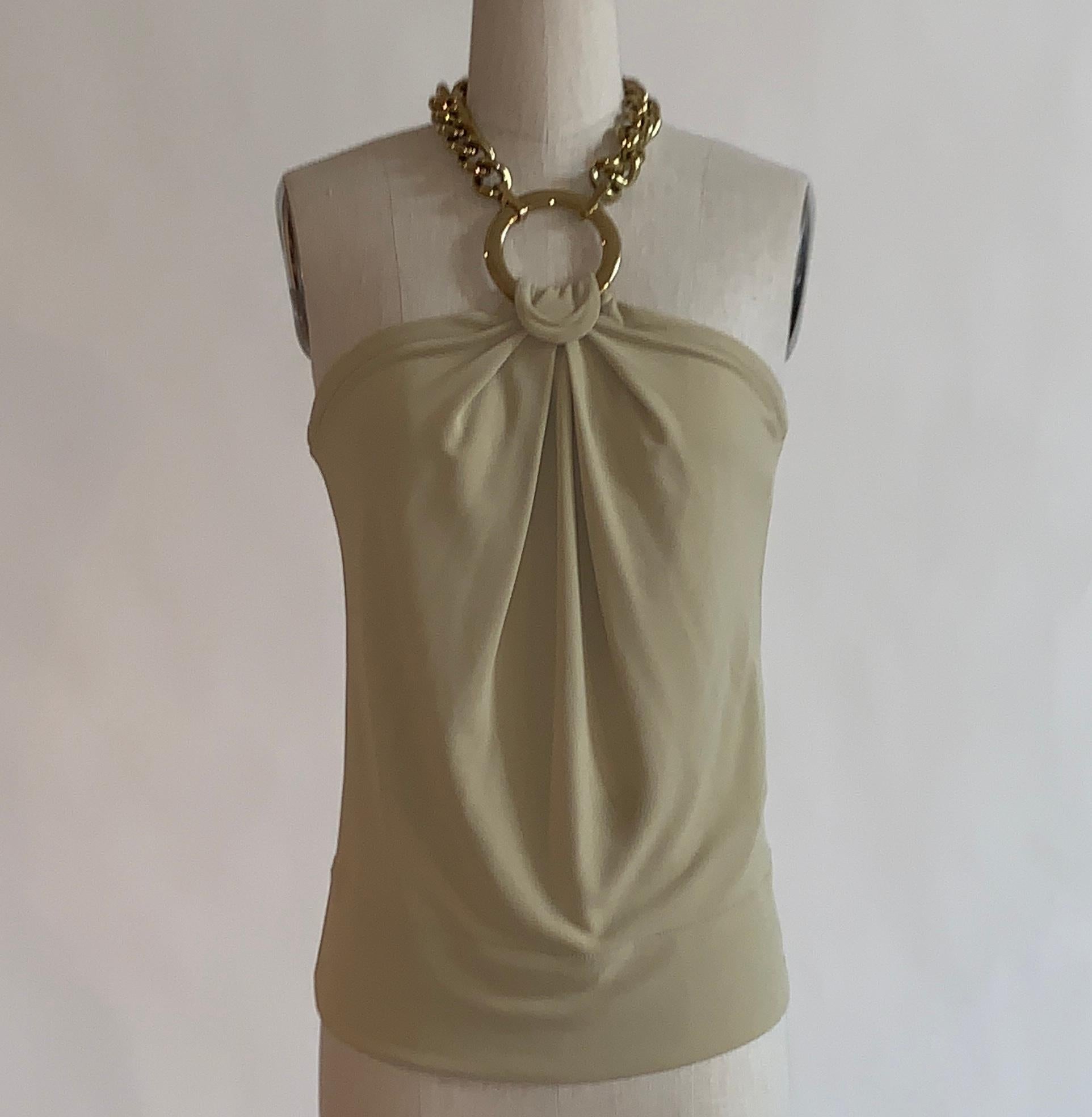 Dolce & Gabbana light tan jersey halter tank with a thick gold chain necklace style closure attached to gold hoop.

80% acetate, 20% nylon.

Made in Italy.

Size IT 40.
Bust 31