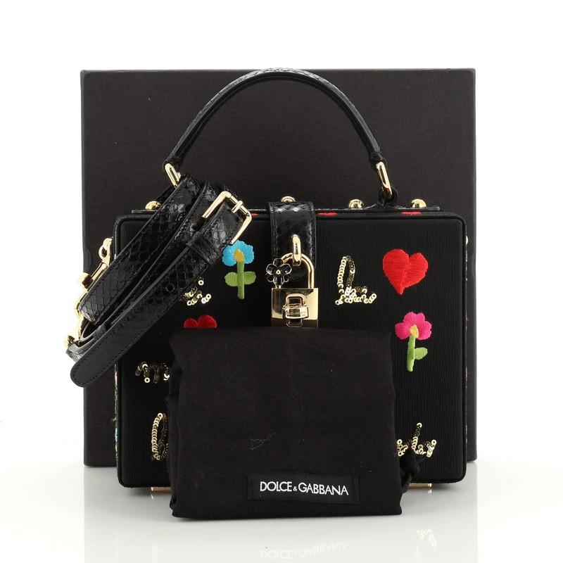 This Dolce & Gabbana Treasure Box Bag Embroidered Grosgrain Small, crafted in black grosgrain, features a top handle, multicolor embroidery and gold-tone hardware. Its turn-lock closure opens to a brown microfiber interior with slip pocket.