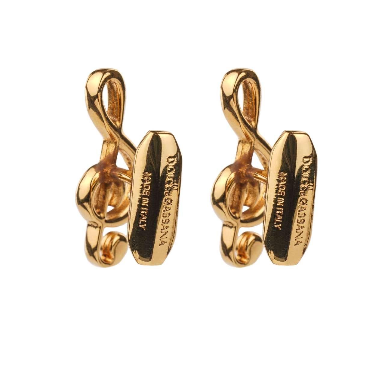- Treble Clef Cufflinks in gold galvanized metal with small red crystal by DOLCE & GABBANA - New with Box - MADE IN ITALY - Former RRP: EUR 195 - Engraved Dolce&Gabbana Logo - Nickel free - Small red crystal - Model: WFJ3S4-W0001-87655 - Material: