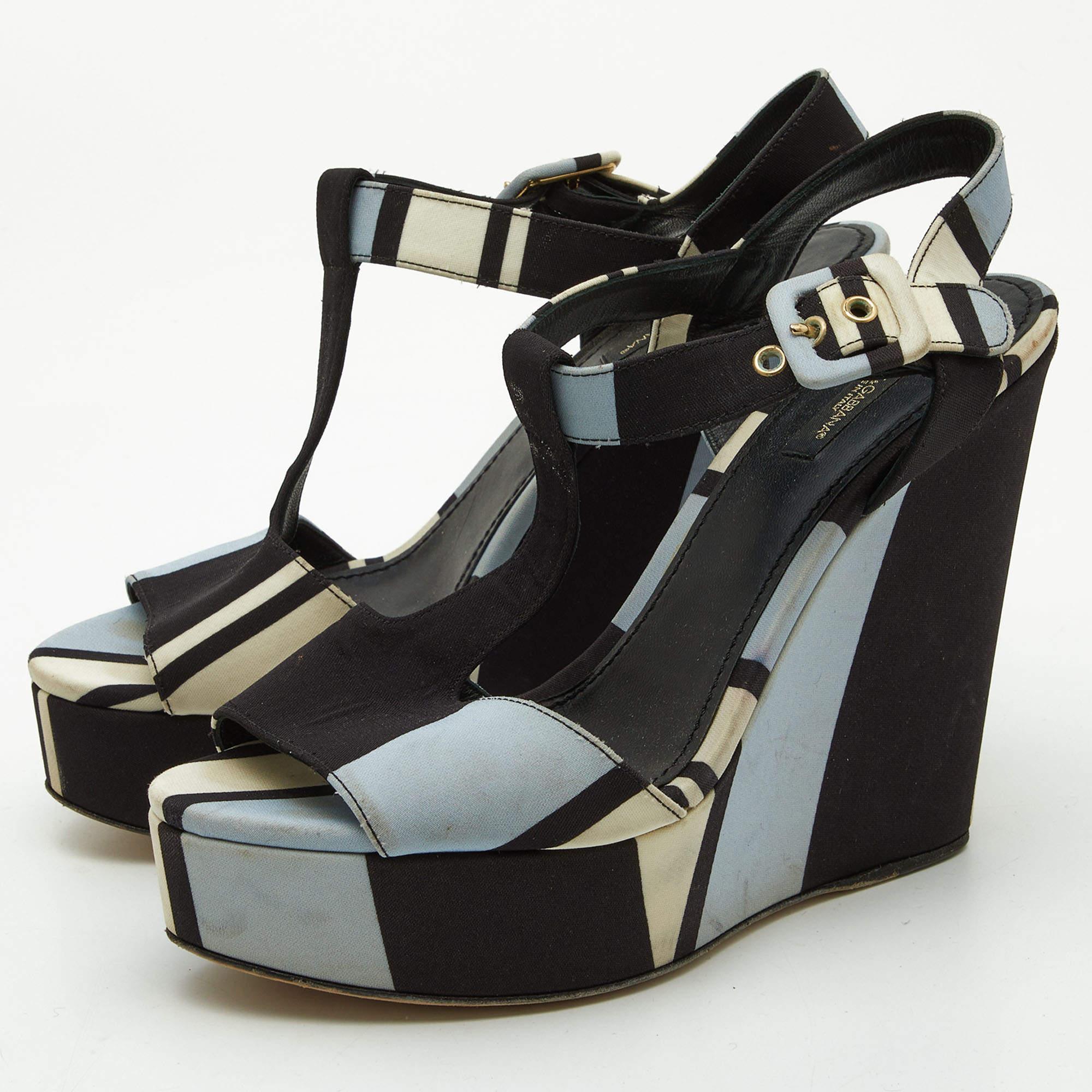 Dolce and Gabbanas Tri Color Printed Fabric T Strap Wedge Sandals feature a vibrant unique print T strap design and comfortable wedge heel offering a blend of elegance and statement making style.