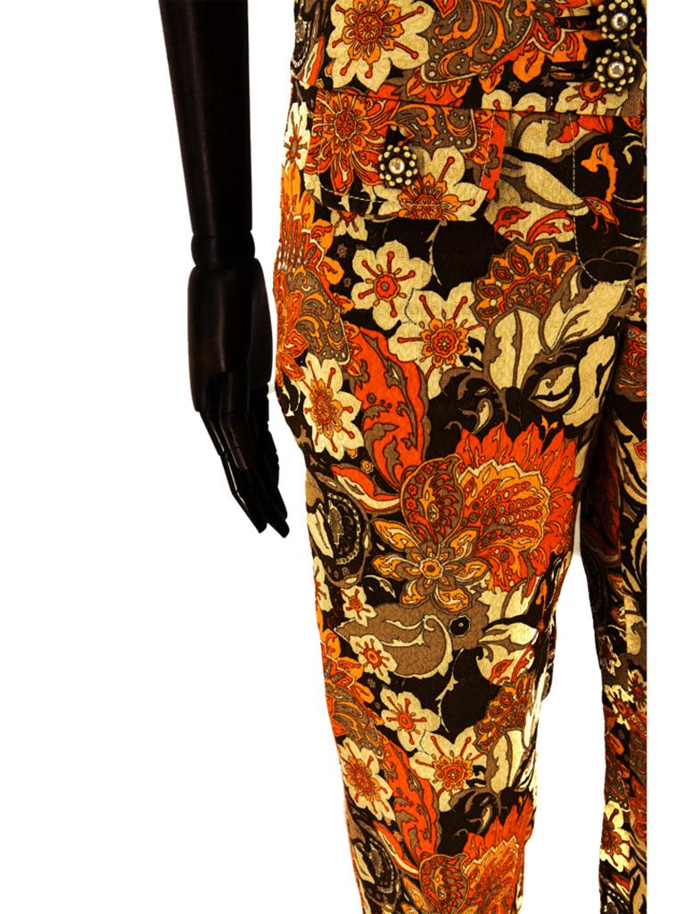 Dolce & Gabbana tailored trousers in a stylised floral 1960s style print in shades of brown and orange from the spring 2004 collection. Complimenting ivory topstitching to the front pocket flaps and fly, waistband finished with two brushed gold