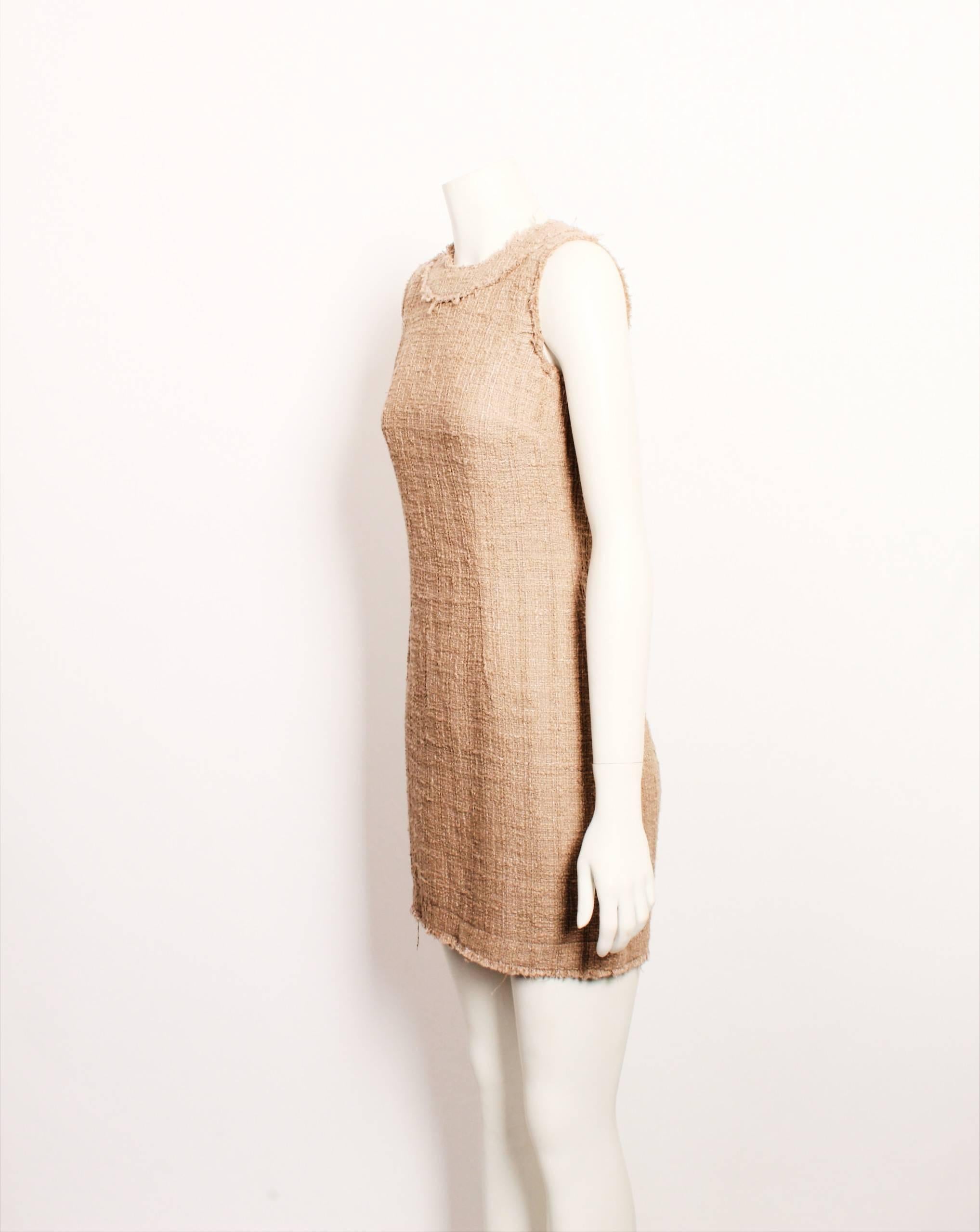 Timeless Dolce & Gabbana beige textural tweed sleeveless mini dress features a fitted body-con silhouette, high round neckline and raw hem finish. Metallic zipper closure with branded pull. Unlined. 
Made in Italy. Size 38. 