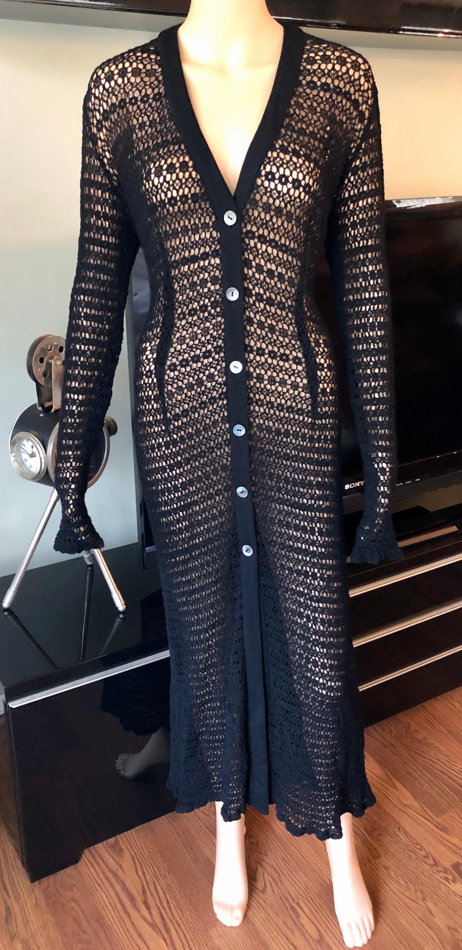 Dolce & Gabbana Vintage 1990's Sheer Open Knit Crochet Fishnet Black Maxi Dress M/L

Dolce & Gabbana vintage dress featuring V-neck, button closures at center front neckline and open knit throughout. The size tag has been removed. The knit is very