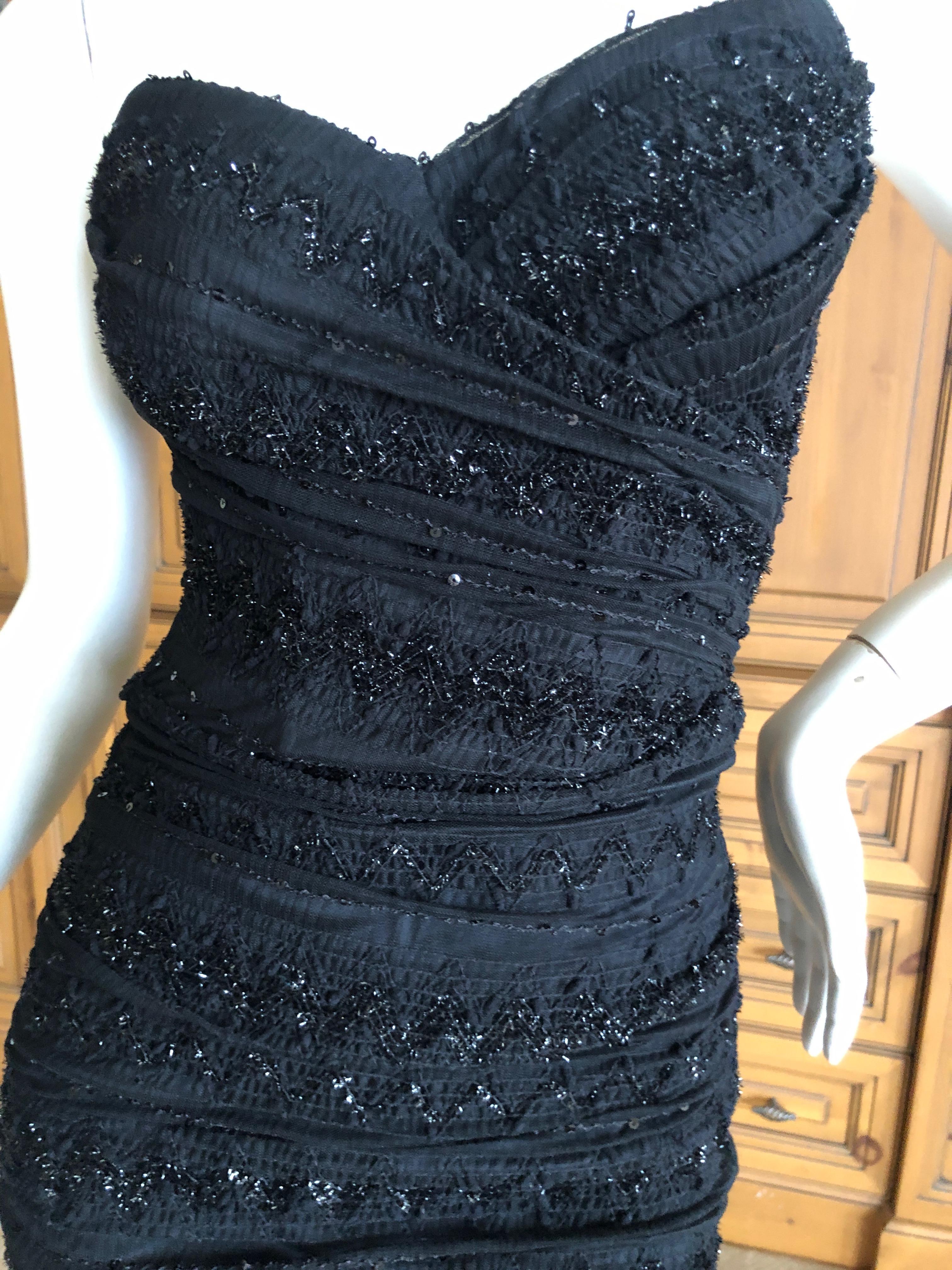 Dolce & Gabbana Vintage Black Strapless Tinsel Cocktail Dress with Inner Corset
So pretty, there is shiny tinsel like embellishment
There is  a lot of stretch
Size 38
Bust 32