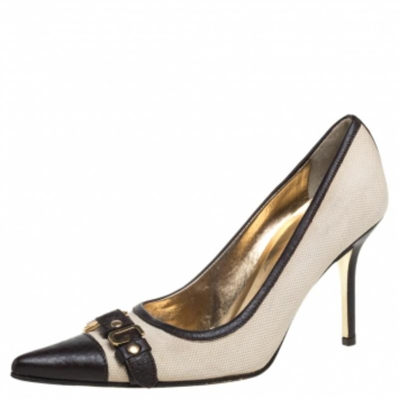 Pick this pair of Dolce & Gabbana pumps to flaunt a simple yet stylish look. Lend an uber-chic look to your ensemble in this pair of pointed-toe pumps, crafted from canvas and leather. Let your shoes talk for your sense of style when you don this