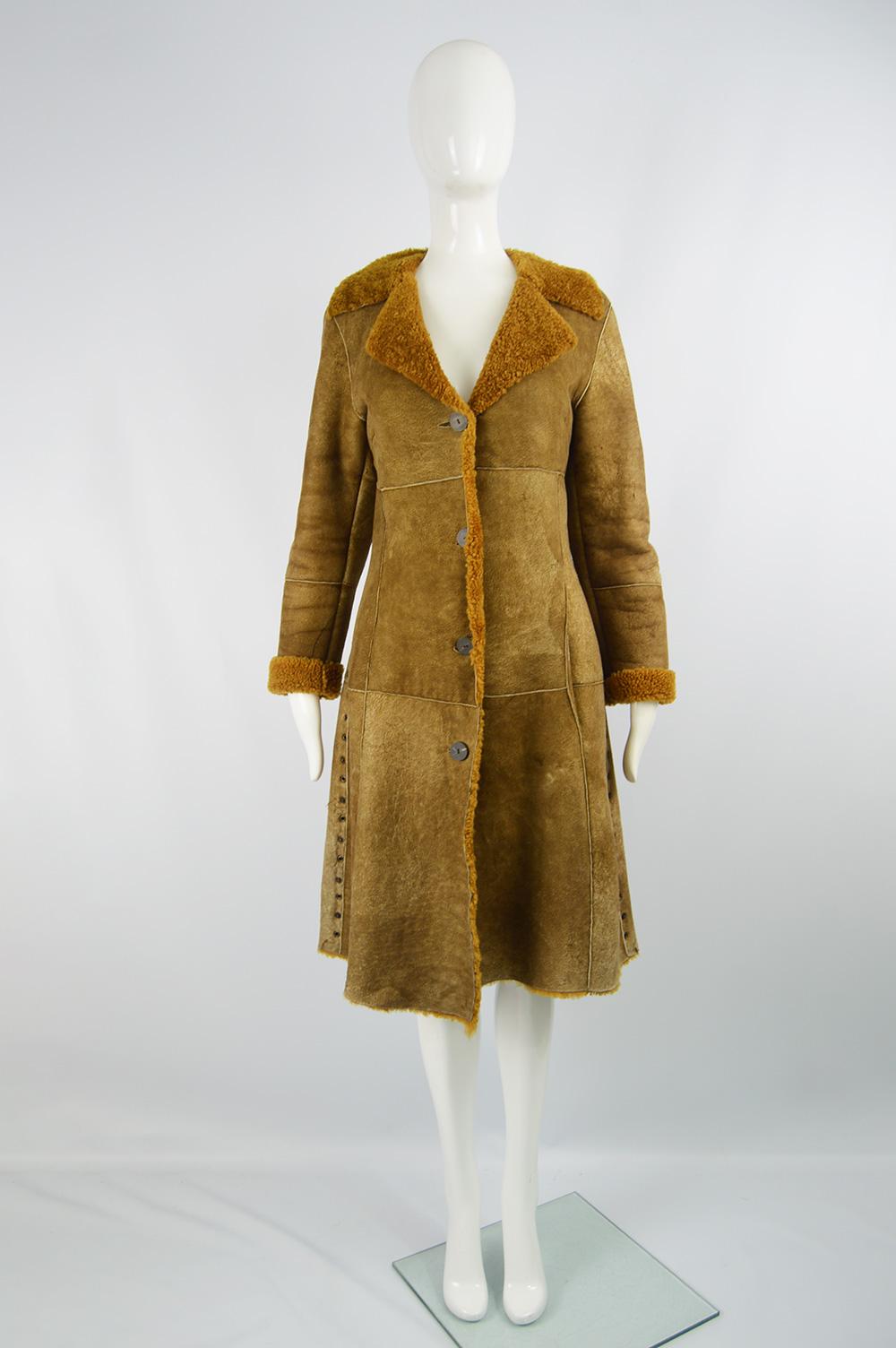 A fabulous vintage Dolce & Gabbana D&G womens sheepskin suede coat with a brown shearling lining and stud details. It has a distressed effect to the exterior and is perfect for autumn winter. 

Size: Marked S. Please check measurements. 
Bust - 34”