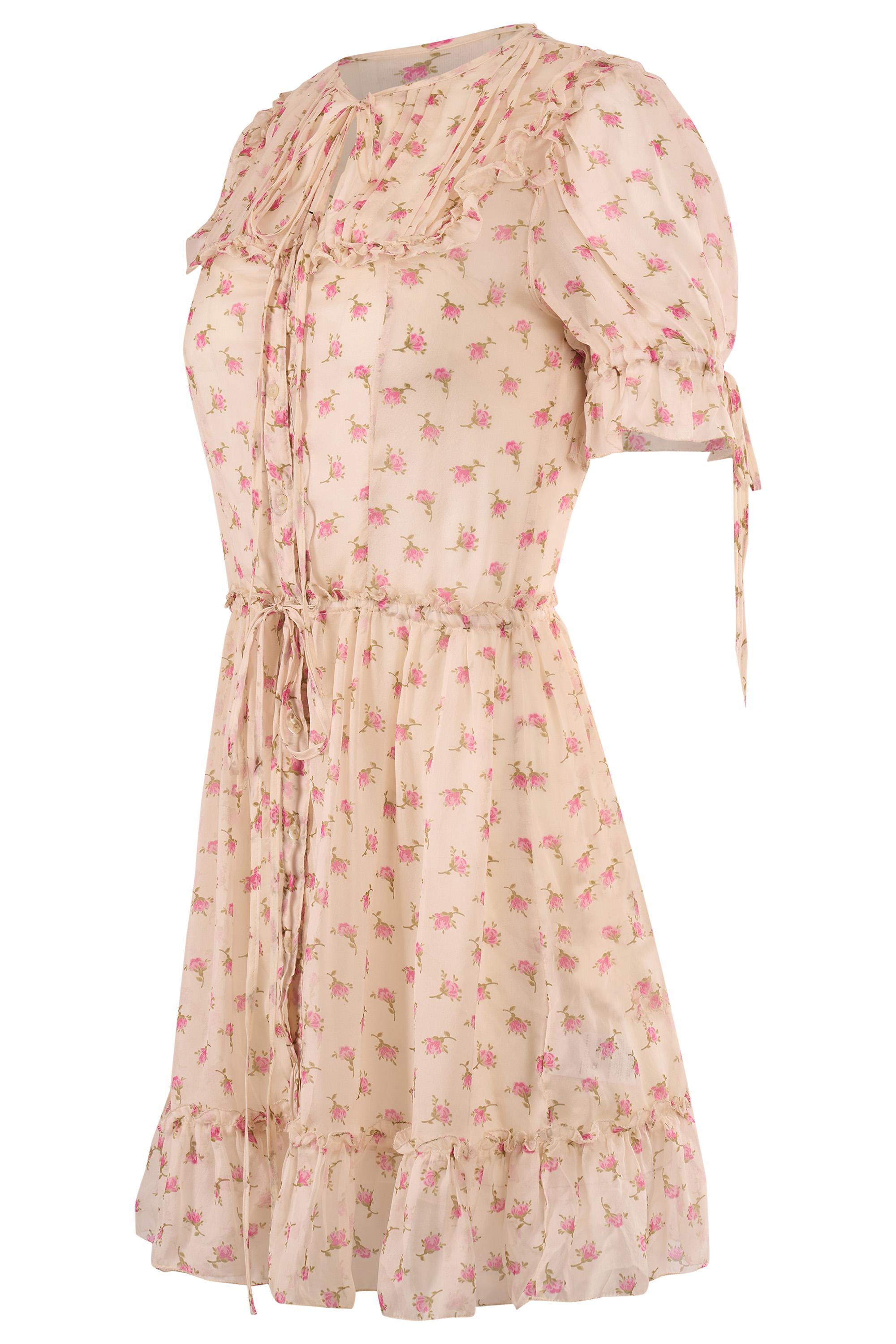 Vintage D&G floral mini dress. Features a airy silk chiffon adorned with a delicate pink rose print.  Puffed short sleeves, button-down front, ruffle trim and pintuck detailing across the bodice. A drawstring waist, adjustable fit, while the
