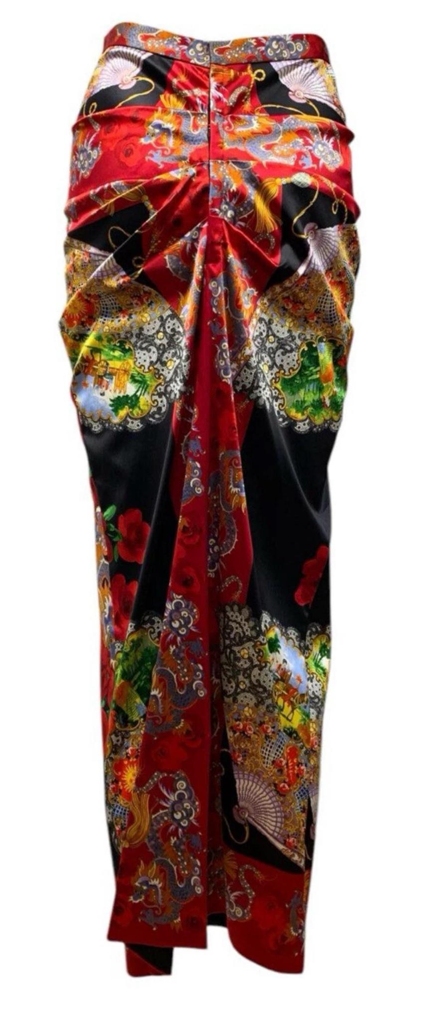 A stunning maxi skirt from Dolce & Gabbana’s celebrated Fall/Winter 1998 collection.
This full-length pencil skirt features a vibrant and intricate exotic Asian motif, with striking dragon and rose print work throughout. Designed with a flattering