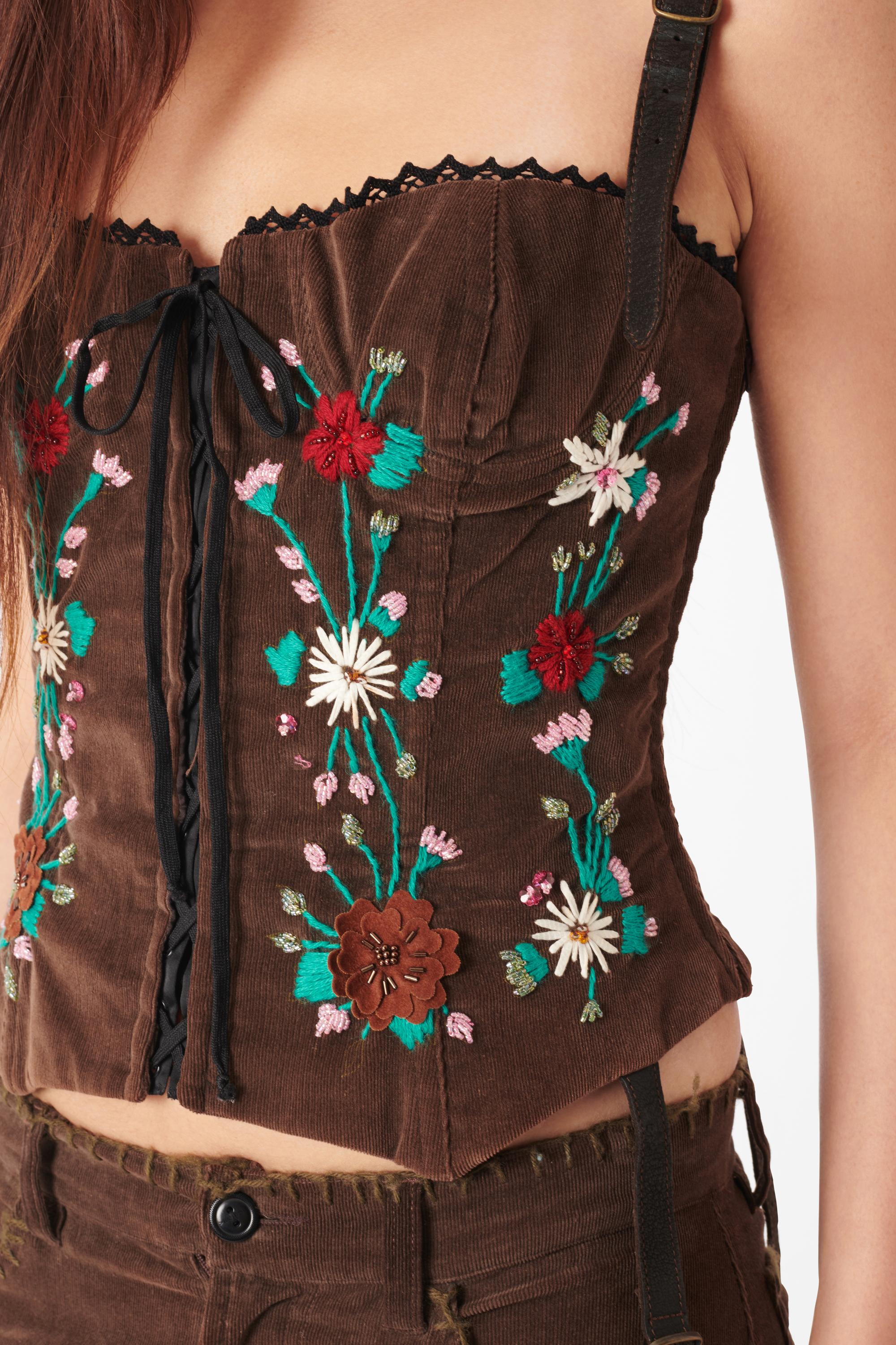 Dolce & Gabbana Fall Winter 2002 corduroy embroidered set. Top features corduroy body with leather suede adjustable straps, bustier silhouette, lace up front and back and embroidered flowers with thread and beading. Trousers feature embroidered