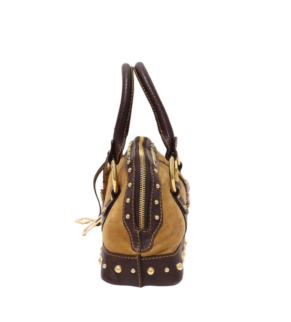 Dolce & Gabbana Vintage Shoulder Bag, Features a gold tone DG charm, leather top handle, and one interior detachable pouch.

Material: Suede, Leather and Pony-hair
Hardware: Gold
Height: 16cm
Width: 29cm
Depth: 9.5cm
Shoulder Drop: 11cm
Overall