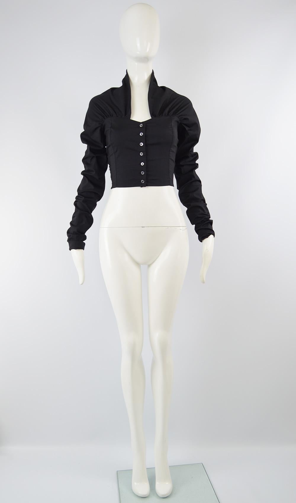 An incredible avant garde women's blouse from the 90s by Dolce & Gabbana. In a black stretch silk and lycra blend, the sleeves are extra long and bunch up to create a ruched effect. The back has a stand up collar almost like a half shawl collar,