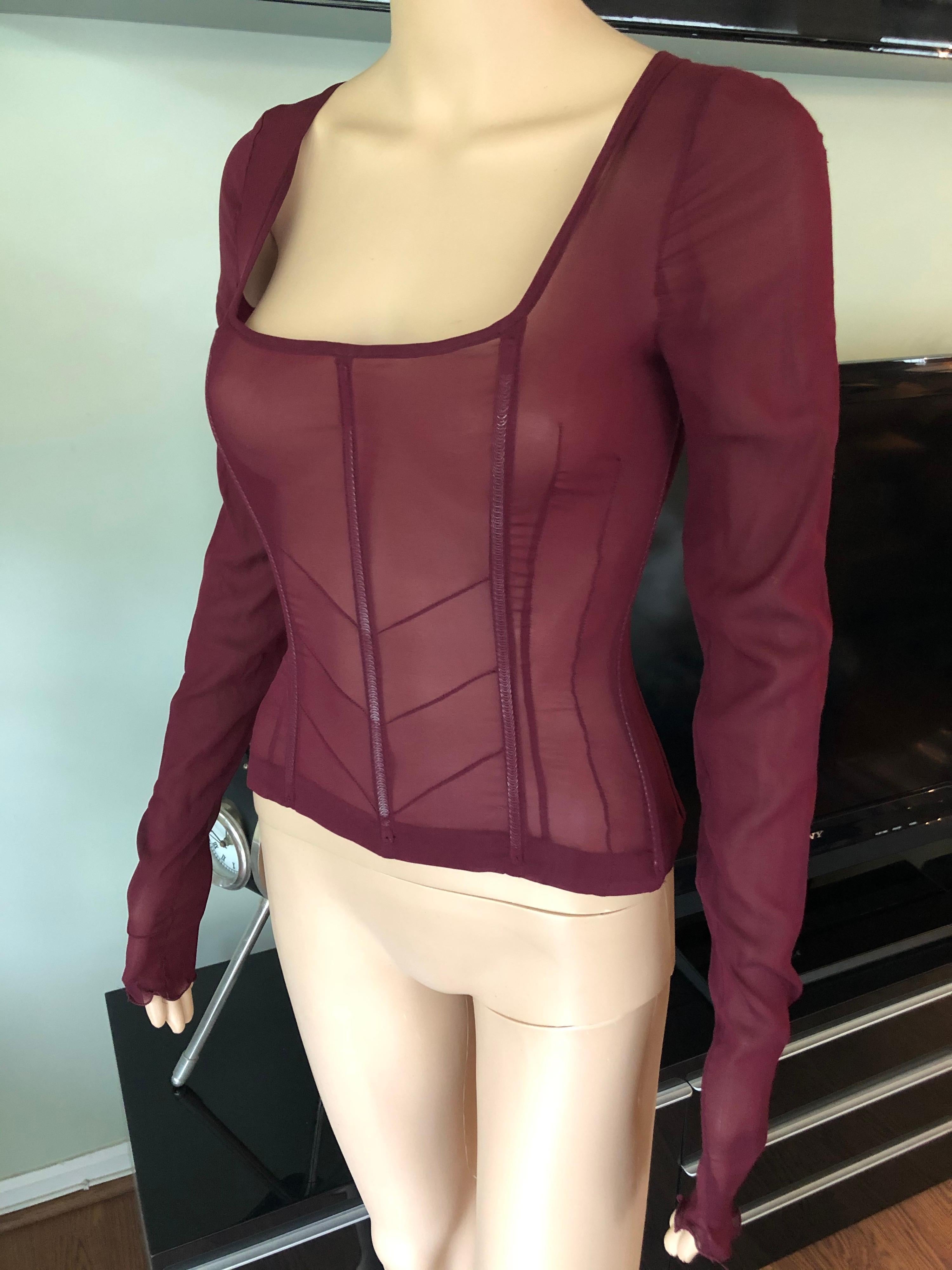Burgundy Dolce & Gabbana sheer silk top featuring sexy neckline, long sleeves, structured bodice and concealed zip closure at back. 
Condition: Unworn Includes Attached Tags

