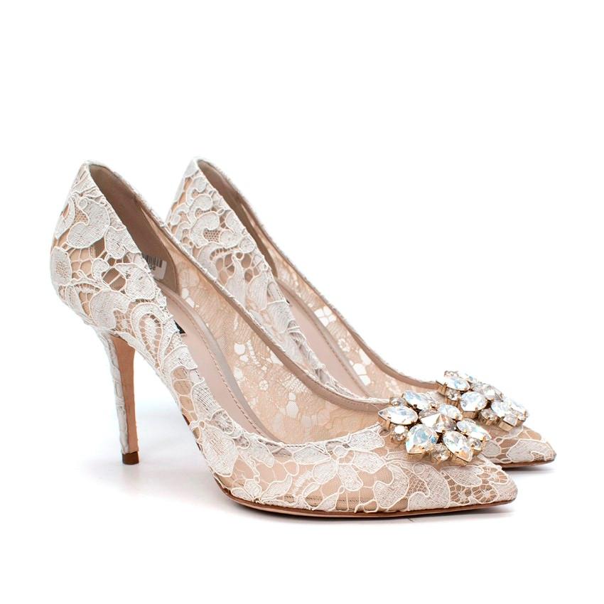 Dolce & Gabbana White Belluci Taormina Lace Embellished Pumps 

- Elegant Belluci style featuring a stiletto heel and pointed toe
- Rendered from Taormina cordered lace, backed with nude mesh for stability
- Iridescant Swarovski crystal
