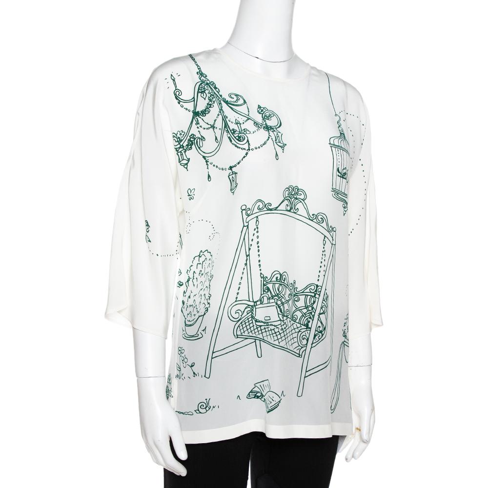 Characterized by a bird and cage print, this blouse from Dolce & Gabbana is crafted with silk flaunting a relaxed silhouette. This lovely piece will look good with loose bottoms for a cool ensemble.

Includes
Price Tag