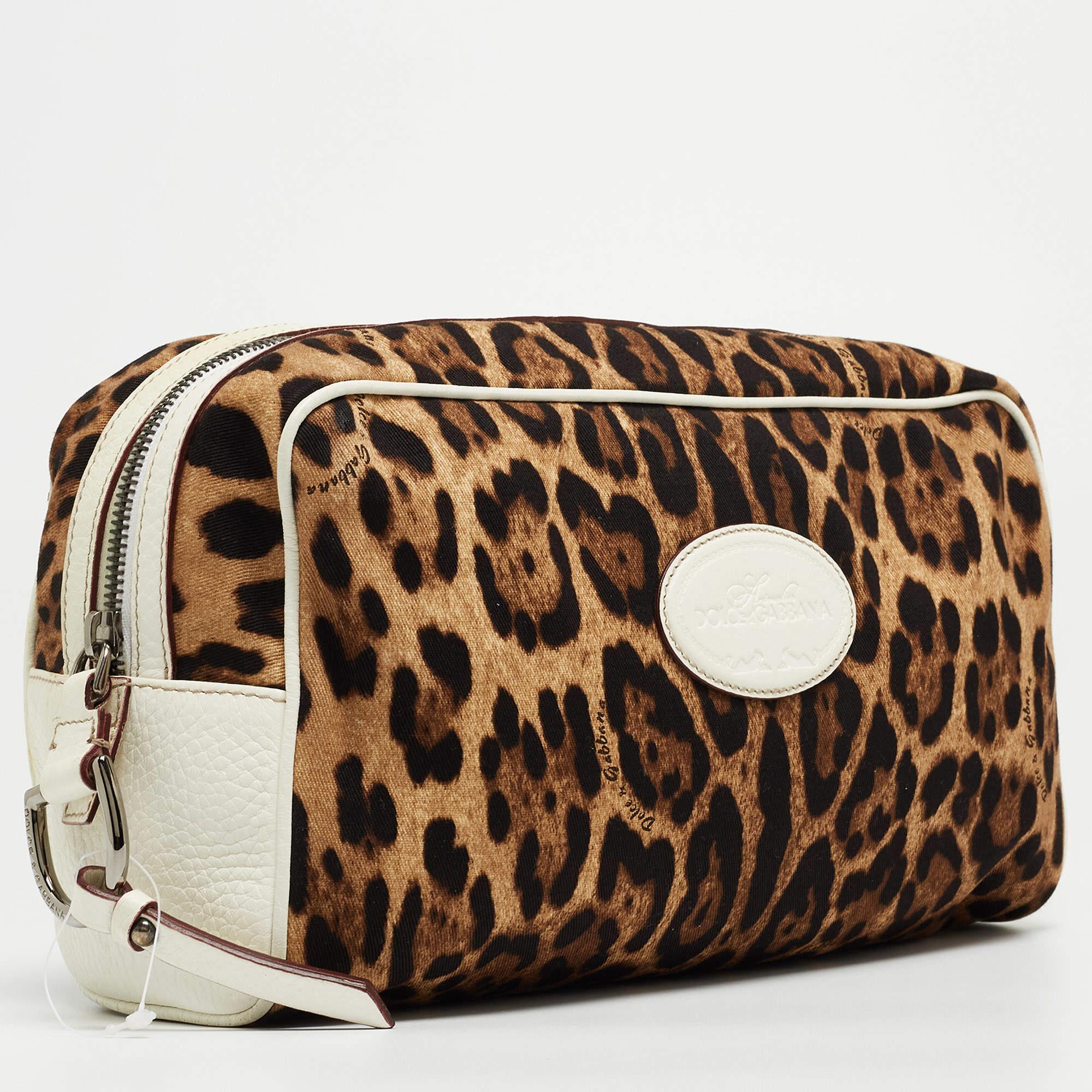 Crafted from leopard print fabric & leather, the Dolce & Gabbana cosmetic pouch is designed to be a handy, durable accessory. The pouch has a zip-enclosed compartment and a brand accent on the front. It will easily fit into your luggage bags and