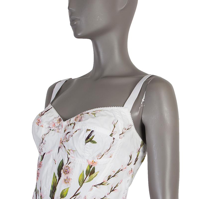 Dolce & Gabbana cherry blossom bustier dress in white, rose, green, brown, and black cotton blend (assumed as tag is missing). With boning on the upper side seams. CLoses with silver-tone zipper on the back. Unlined. Has been worn and is in