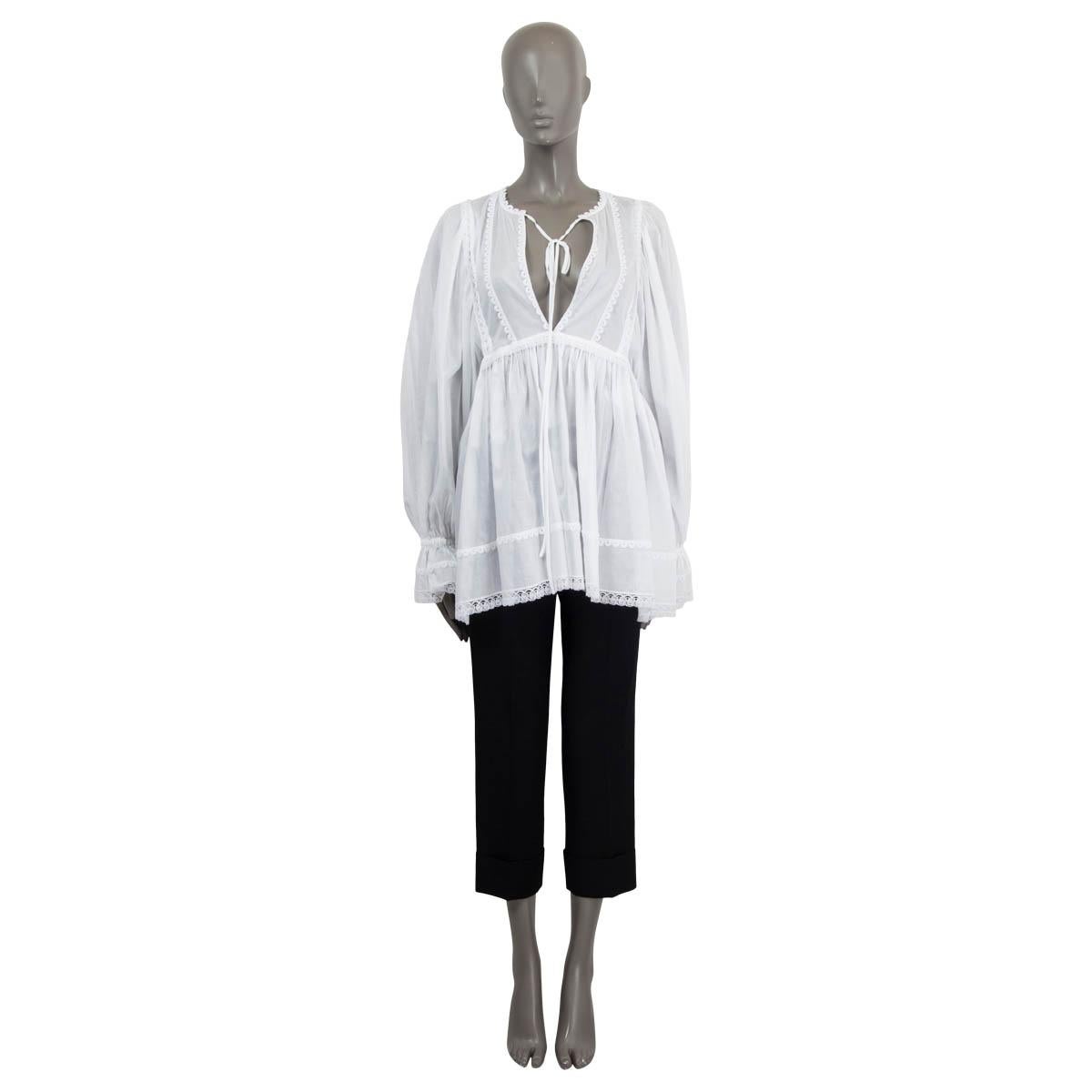 100% authentic Dolce & Gabbana babydoll tunic blouse in white cotton-blend voile (missing tag) with lace-trim and gathered accents on cuffs, chest and trim. Opens with a zipper on the back. Unlined. Has been worn and is in excellent condition.