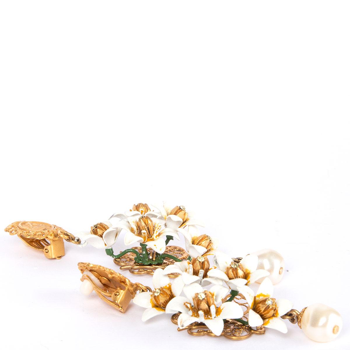 100% authentic Dolce & Gabbana gold-tone brass ear-clips with embossed icon coin and white enamel flowers and faux pearl. Have been worn and are in excellent condition.

Width	3cm (1.2in)
Length	8.3cm (3.2in)

All our listings include only the