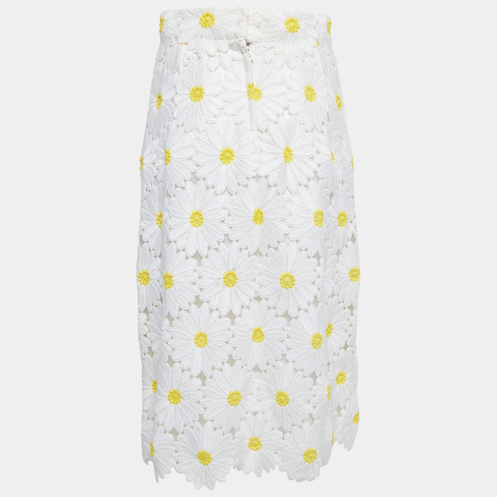 This midi skirt from the House of Dolce & Gabbana is a beautiful creation that will add grace to your ensemble. It is fashioned in white Guipure lace fabric, which is augmented with sunflower appliques. It is equipped with zipper closure. Match this