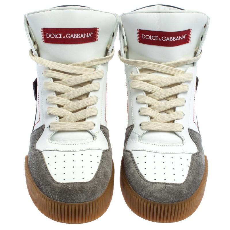 Bring home the luxurious high-fashion touch with these high-top sneakers from Dolce & Gabbana. Crafted from white leather and grey suede, these sneakers come flaunting lace-ups on the vamps, exaggerated tongues with the brand labeling, and wide logo