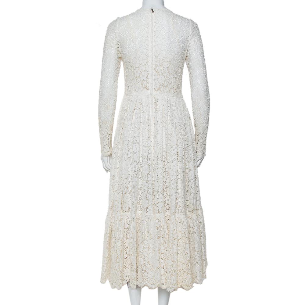 This delicate dress is beautified with a flared silhouette and intricate lace. This Dolce & Gabbana maxi dress will make you look no less than a princess. The pleasing white-hued outfit is adorned with lacework. Featuring a fitted top and a flared