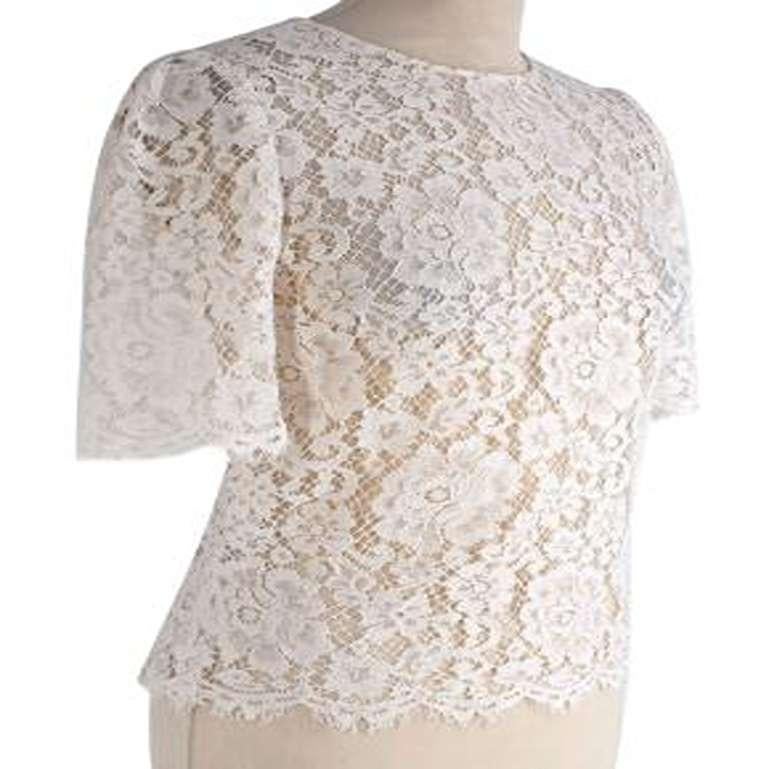 Dolce & Gabbana White Lace Top

- Made of lavish lace.
- Perfect fitting top.
- Stunning lace floral applique. 

No country of origin.
No care label.
Condition 9.5/10. great condition

PLEASE NOTE, THESE ITEMS ARE PRE-OWNED AND MAY SHOW SIGNS OF