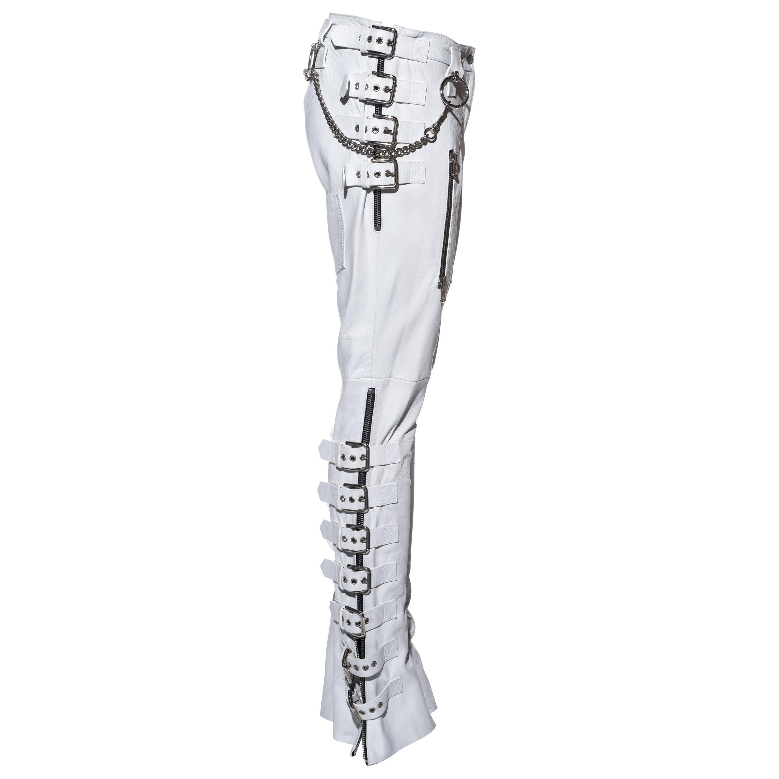 ▪ Dolce & Gabbana white lambskin leather pants  
▪ 100% Lambskin leather
▪ Twenty-two metal buckles  
▪ Zip-up sides and pockets  
▪ Four metal hoops with metal chain 
▪ IT 42 - FR 38 - UK 10 - US 6 
▪ Spring-Summer 2003