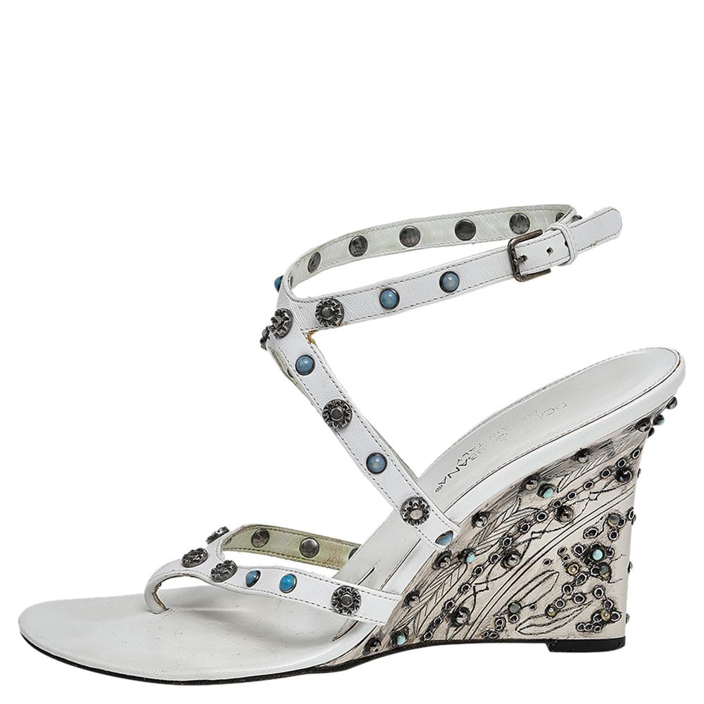 Coming from the House of Dolce & Gabbana, these sandals will add refinement and poise to your attire. They are crafted using white leather on the exterior with dainty embellishments decorating the upper. They come with an ankle-strap feature,