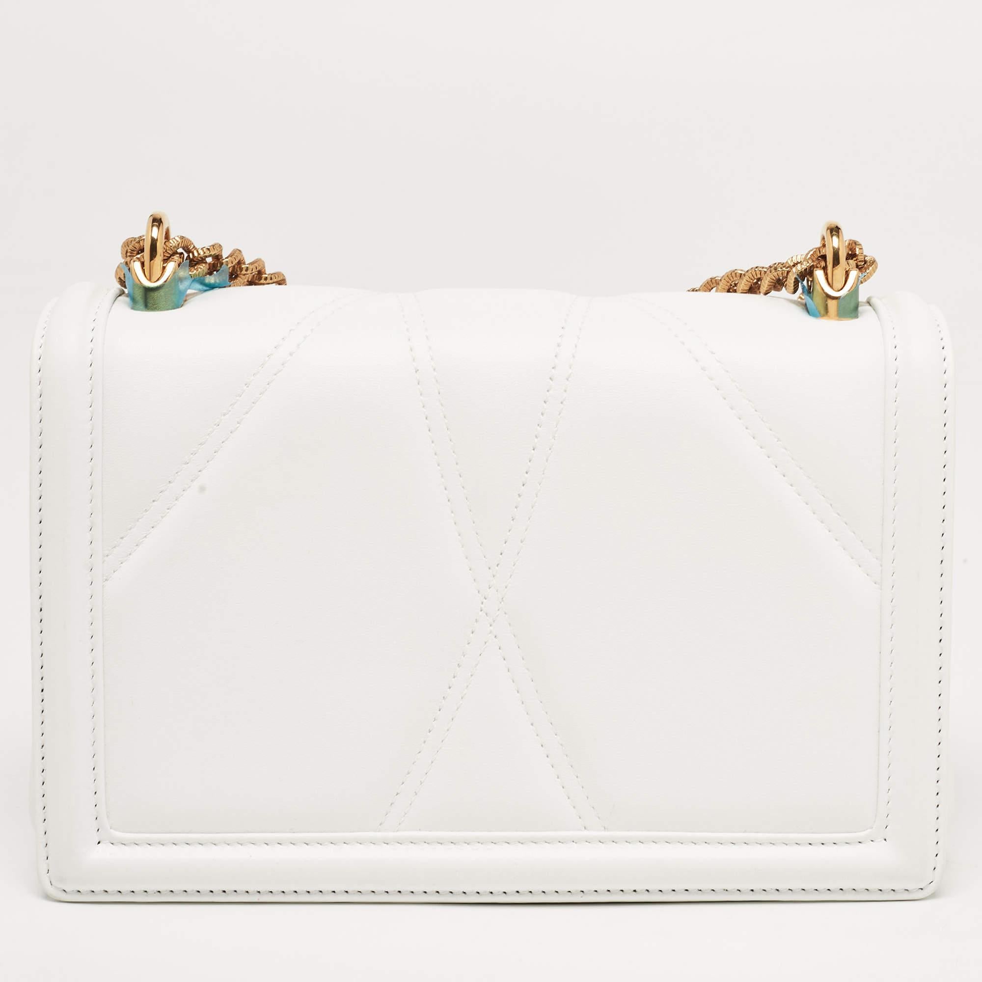 This Devotion Mordore shoulder bag from the House of Dolce & Gabbana is both elegant and fashionable. Crafted from white leather on the exterior, this bag features a top handle, gold-tone hardware, and a leather-lined interior. It has an additional