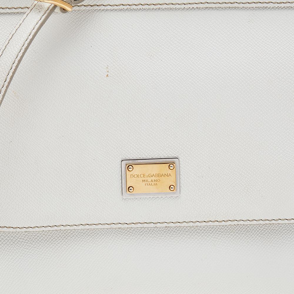 The iconic Miss Sicily bag by Dolce & Gabbana is named after Domenico Dolce's native land and exhibits the aesthetic of Italian glamour. The neat silhouette is made from leather in a white shade and features a front flap accented with the signature