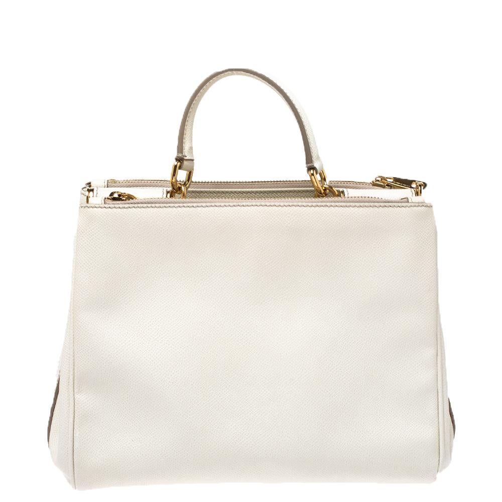 Whether it is a casual evening or a night out with your friends, this Miss Sicily bag is a splendid pick for any occasion. This bag from the house of Dolce & Gabbana is crafted from white leather and has a structured design that comes with a top