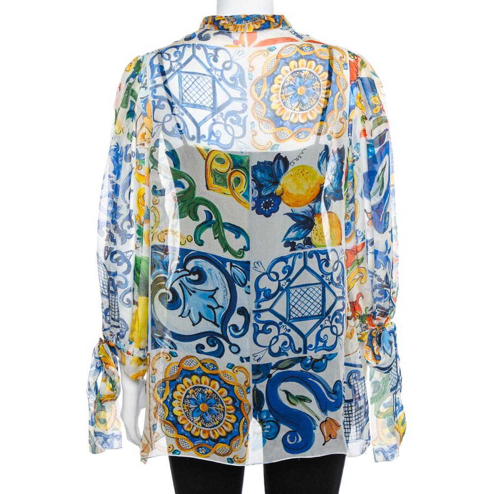 The majolica print is synonymous with Dolce & Gabbana and the same is beautifully presented in this top. It is made of 100% silk and features a sheer effect and ties on the neckline and long sleeves. Pair the top with a high-waist skirt or shorts