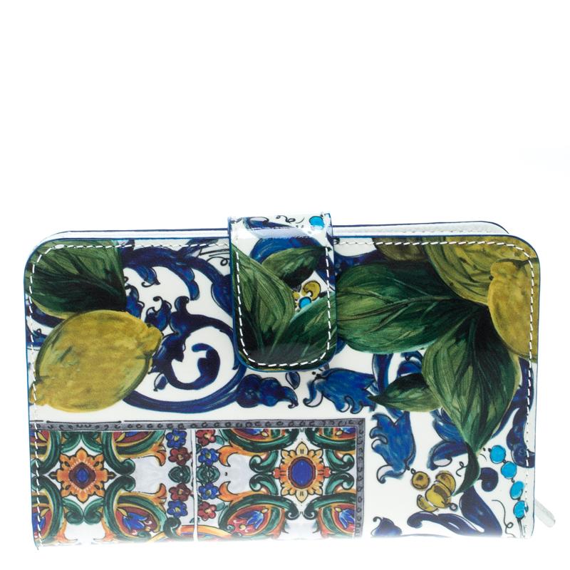 From the house of Dolce & Gabbana comes this fabulous French wallet that is functional and stylish. It is made from white leather accented with a multicolored print all over and lined with leather on the insides. The wallet comes with two