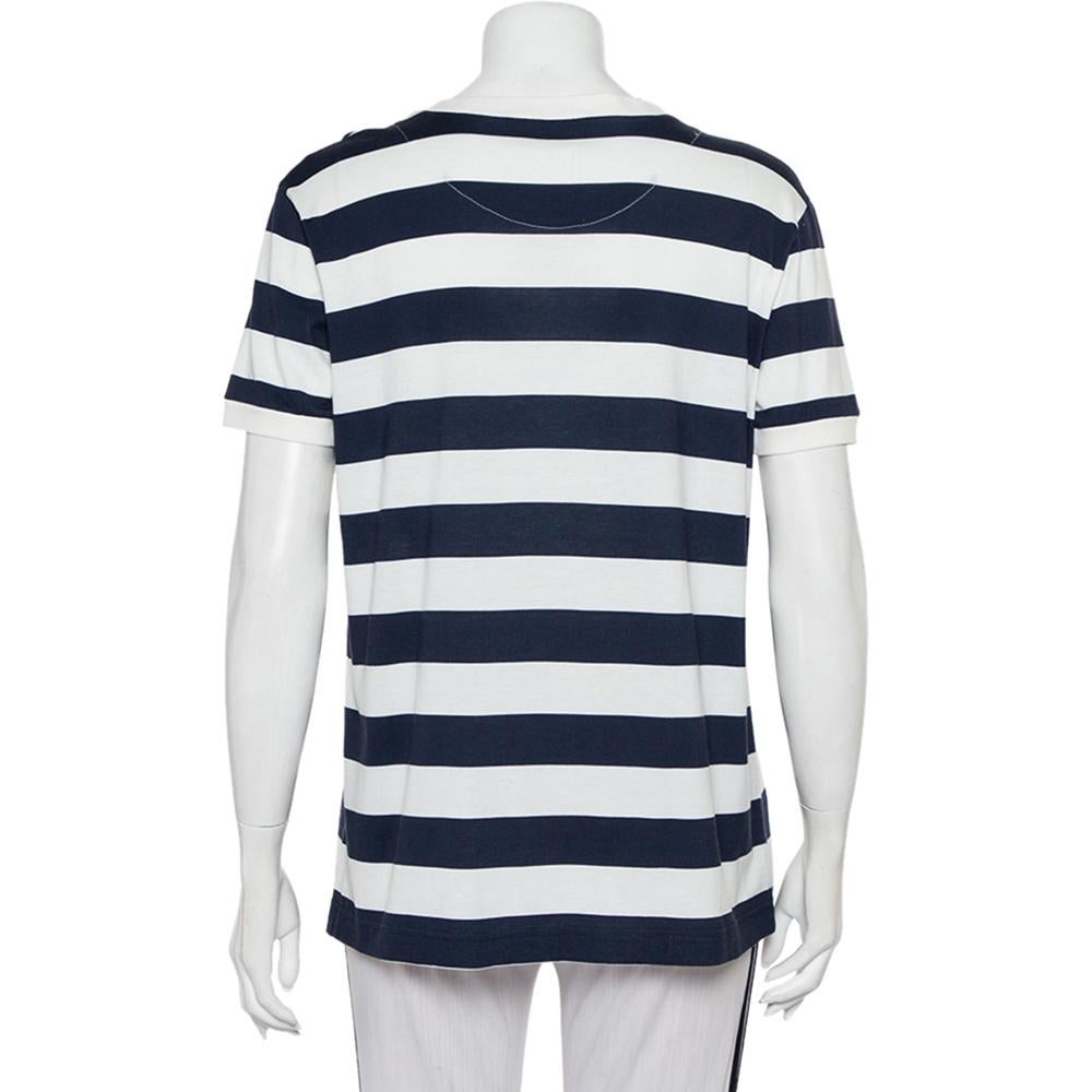A seamless blend of comfort, luxury, and style, this Dolce & Gabbana t-shirt is a must-have piece! Made from striped cotton in white & navy blue shades, the creation is elevated by patches on the front. Finished off with short sleeves and a
