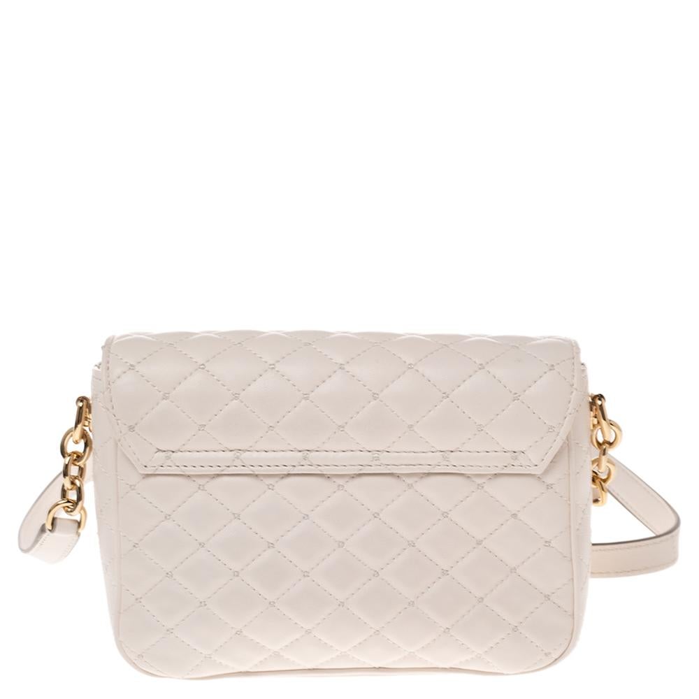 This Dolce & Gabbana bag is a must-have for the fashion-conscious. Embrace your natural style with this alluring shoulder bag. Crafted from quilted leather, it has a lovely white shade and a crystal-embellished DG logo on the front flap. The