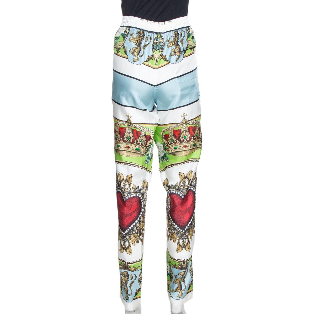 These trousers from Dolce & Gabbana is a creation that you cannot let go of. They have been crafted from silk and features signature prints including the crown and heart all over. These trousers are styled with a tapered leg and button fastening.