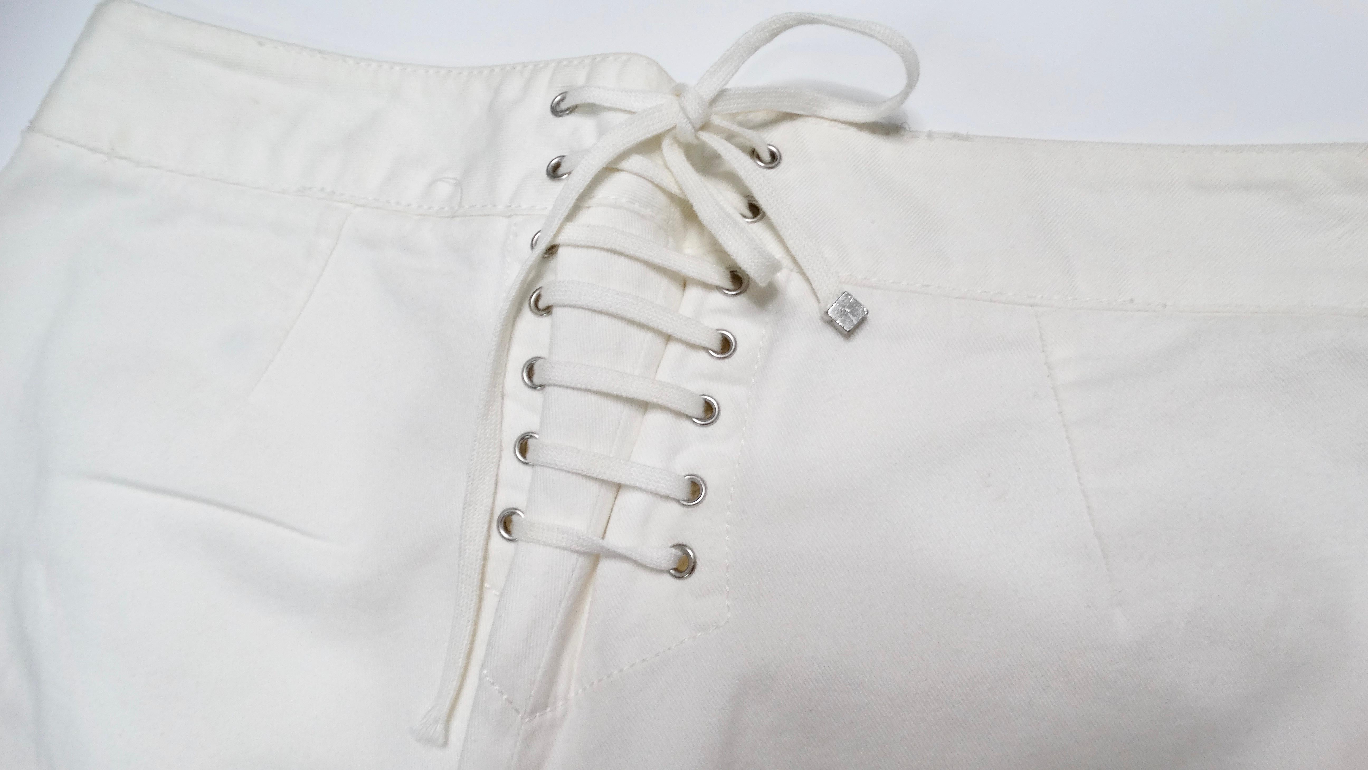 Embrace timeless Italian elegance with the Dolce & Gabbana White Button Detailed Straight Leg Jeans. Crafted from premium 100% cotton, these jeans exude a sophisticated casual style.  Silver-tone button detailing graces the front, creating a