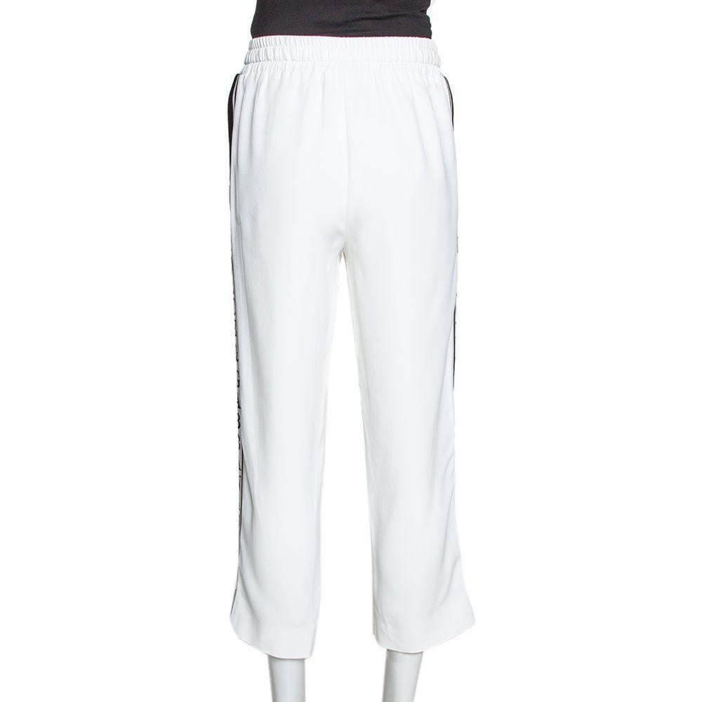 Boost your look with this basic jogger from the house of Dolce & Gabbana. It is made from stretchable fabric to give it an effortless look. The pants have a stretch waistband, pockets with branded zippers and sliders, stitched pleats for a