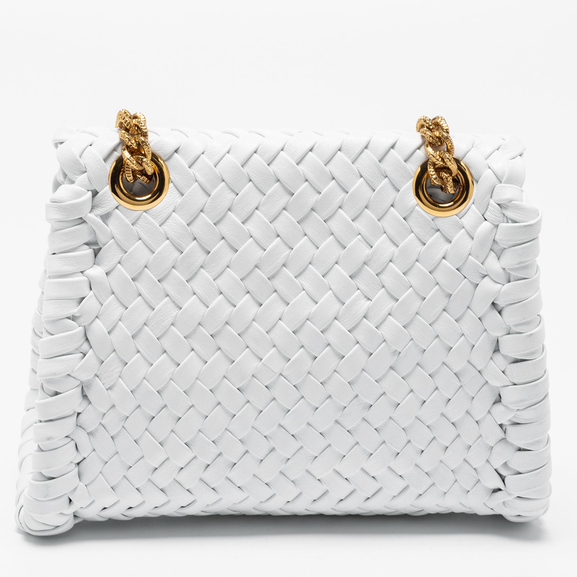 First introduced in the Fall/Winter 2018 collection, the Dolce & Gabbana Devotion bags are famous for their drone-driven runway entry. This version is crafted from woven leather in a white shade and sealed with a crest-like heart-shaped Devotion