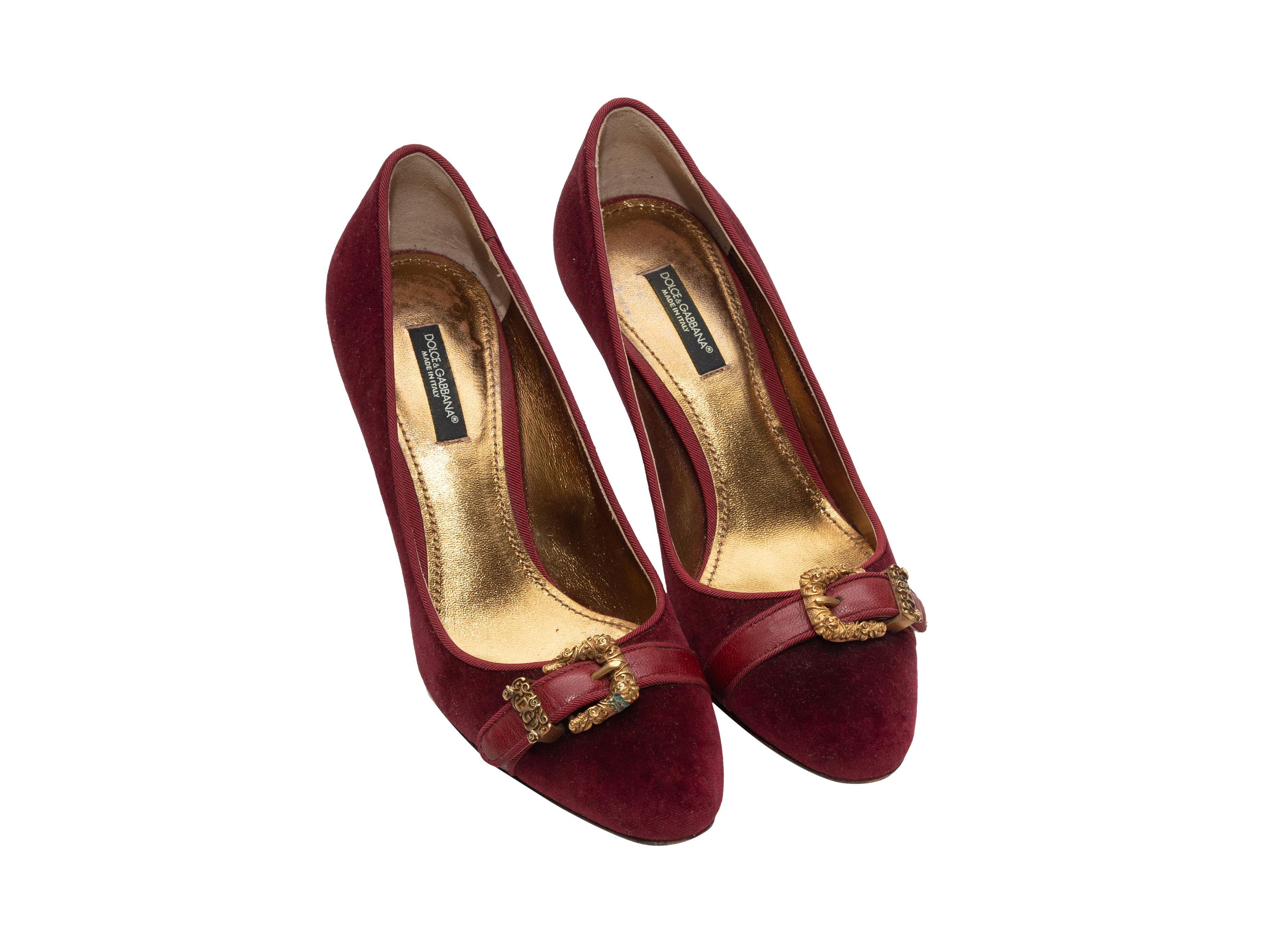 Product details: Wine velvet pumps by Dolce & Gabbana. Gold-tone buckle accents at toes. 3.5