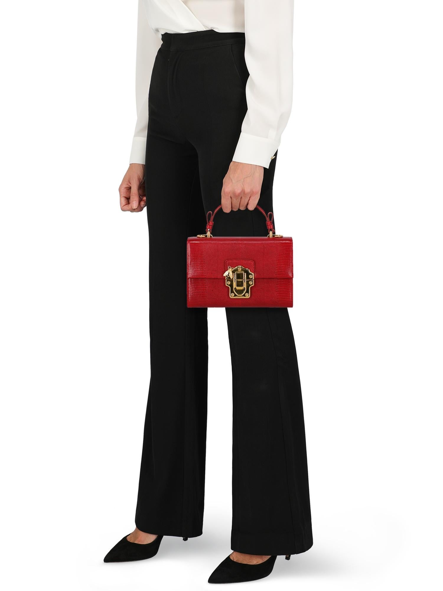 Lucia, leather, snake print, front logo, pressure lock closure, gold-tone hardware, internal mirror, internal zipped pocket, internal pocket, day bag

Includes:
- Dust bag
- Shoulder strap

Product Condition: Excellent
Lining: negligible residues.