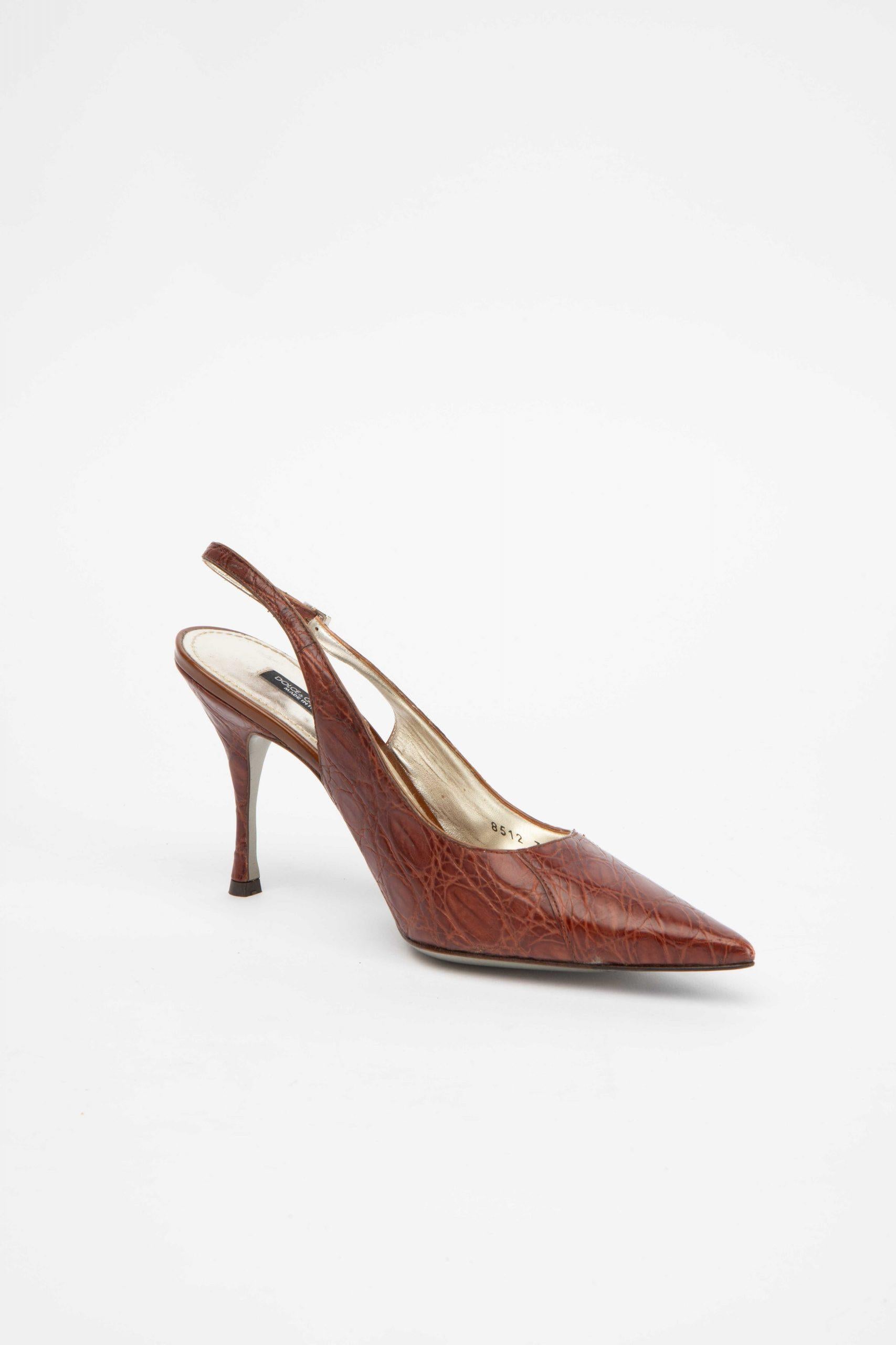 CONDITION is Very good. Minimal wear to heels is evident. Minimal wear to the ankle straps and the insole on this used Dolce & Gabbana designer resale item. 
 
 Details
  Brown
 Crocodile skin leather
 Slingback heels
 Pointed toe
 High heel
 Ankle