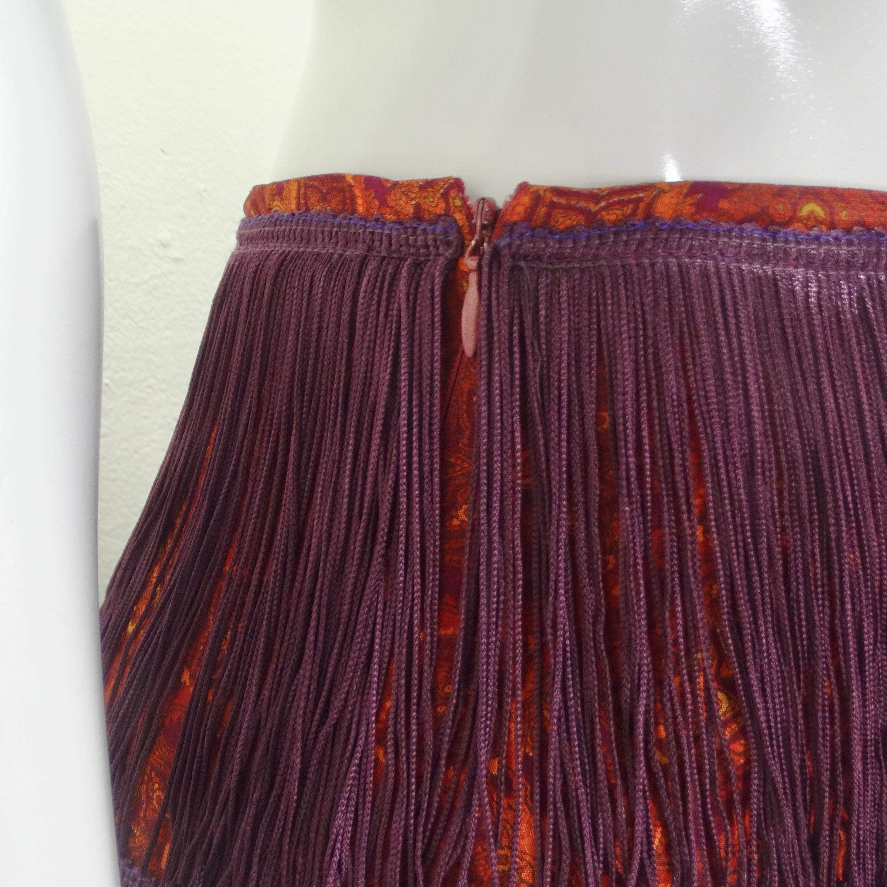 Get your hands on the Dolce & Gabbana Y2K Fringe Maxi Skirt – a captivating and lively piece that perfectly captures the spirit of the early 2000s. The early 2000s were all about bold, expressive fashion, and this skirt is a fabulous nod to that
