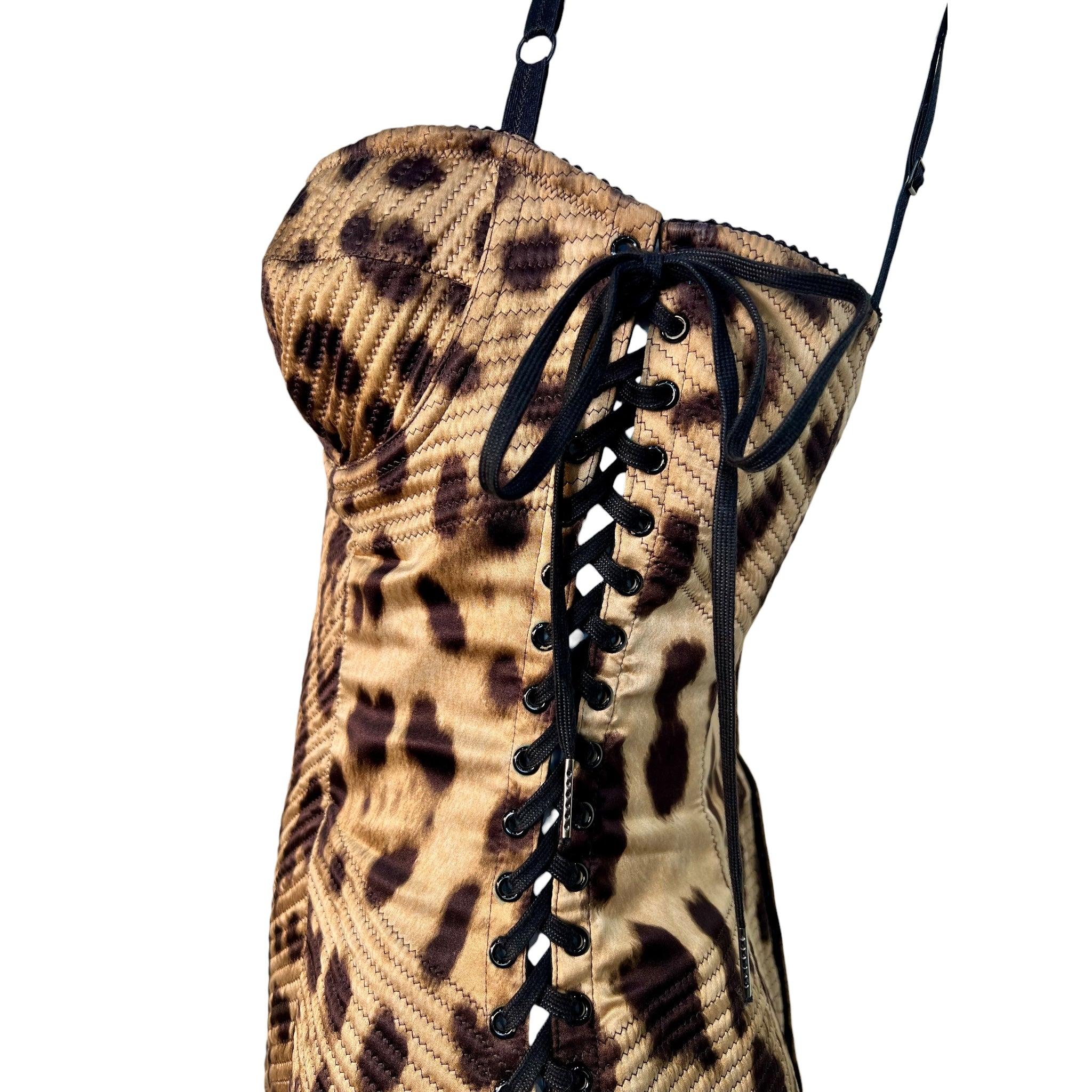 Get ready to turn heads in this drop dead gorgeous Dolce & Gabbana black label dress. Wild jumbo leopard print with decorative quilting. Corseting lace-up grommet detail on both sides. Bustier cups and adjustable shoulder straps. Sexy back hook and
