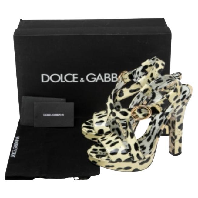 These gorgeous sandals from Dolce & Gabbana are crafted from animal-printed patent leather and feature an open-toe silhouette. They flaunt cross straps on the vamps and come equipped with comfortable leather-lined insoles, buckled ankle straps, 14