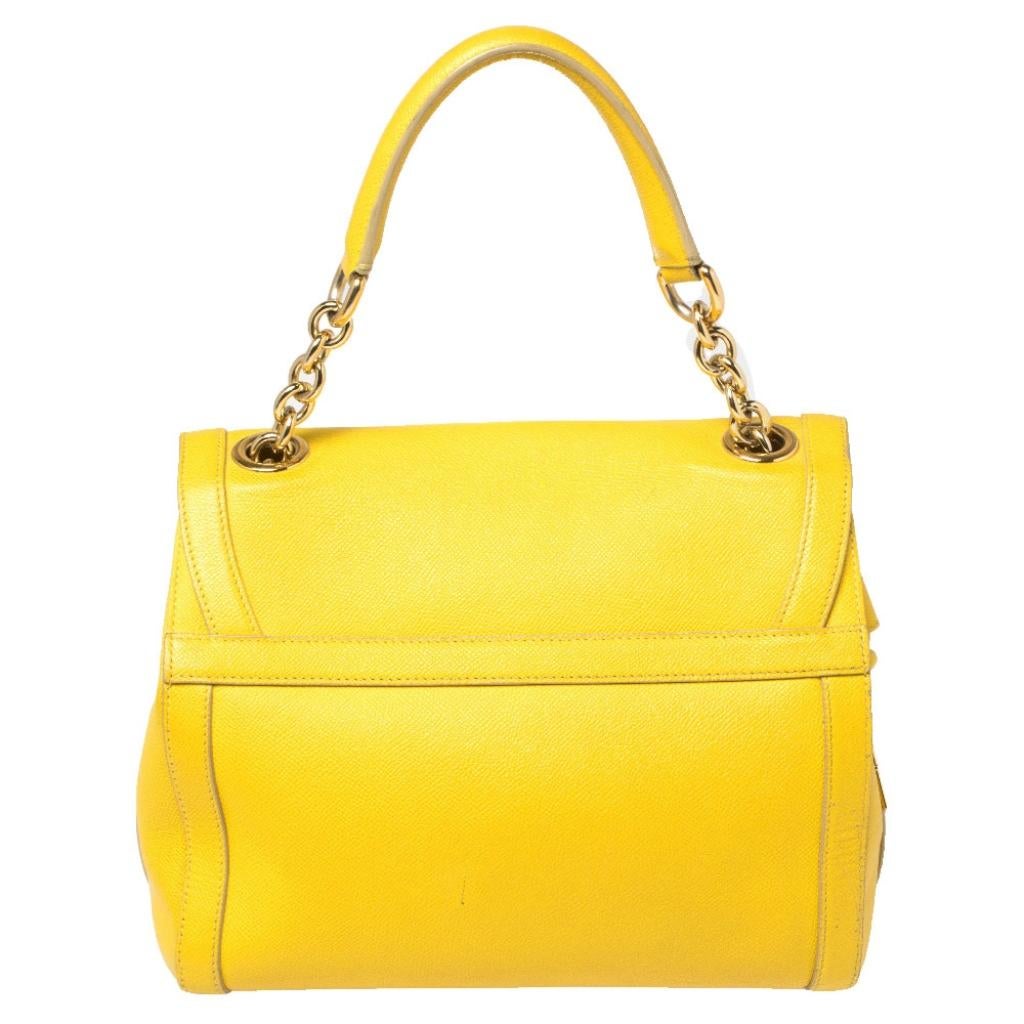 Every feature on this Dolce & Gabbana bag is delightful that makes the creation worthy of being owned. It has been crafted from leather and styled with a padlock that has a turn lock. The bag has a top handle, a shoulder strap, and a fabric interior