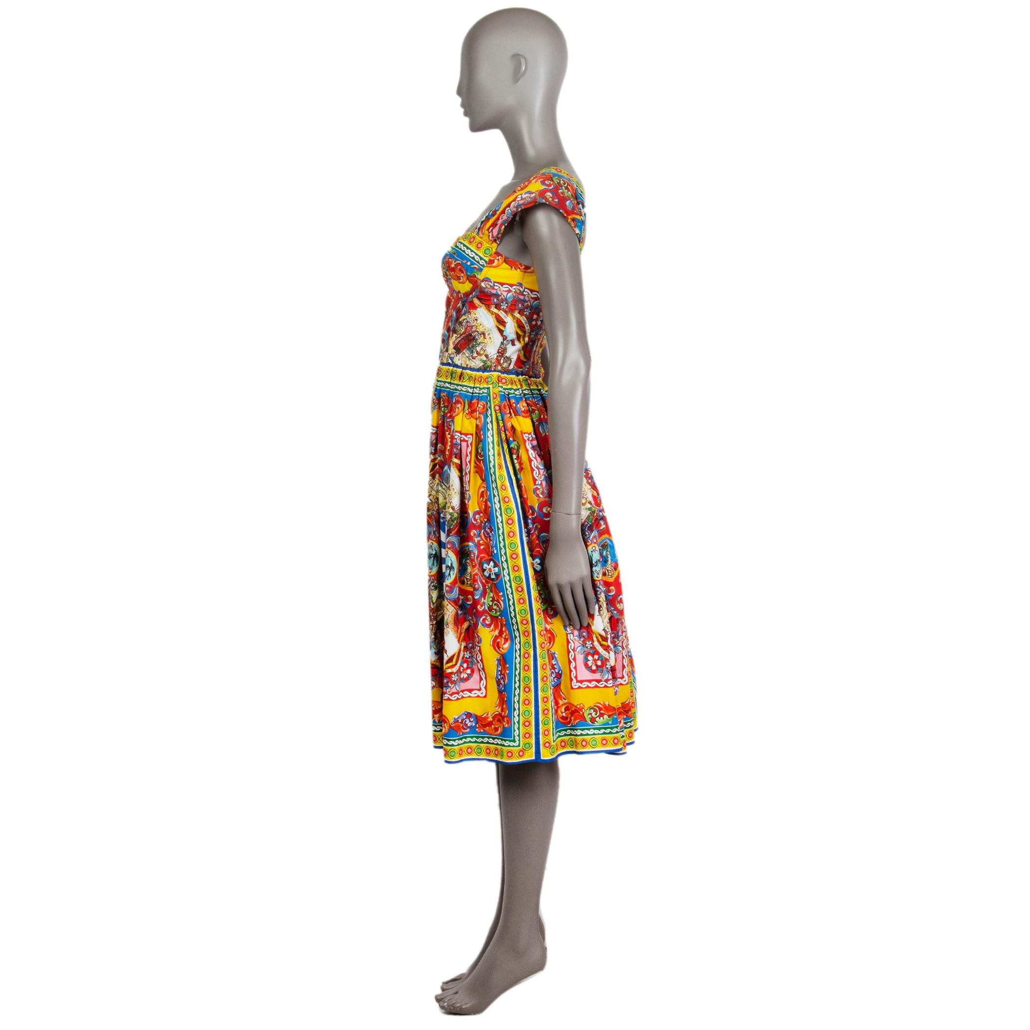Dolce & Gabbana 'Teatro dei Pupi' dress in red, yellow, blue, green, rose, orange, and white cotton (100%). With cap sleeves, inside wiring around the bust for support, and pleated skirt. Closes with concealed metal zipper on the back. Unlined. Has