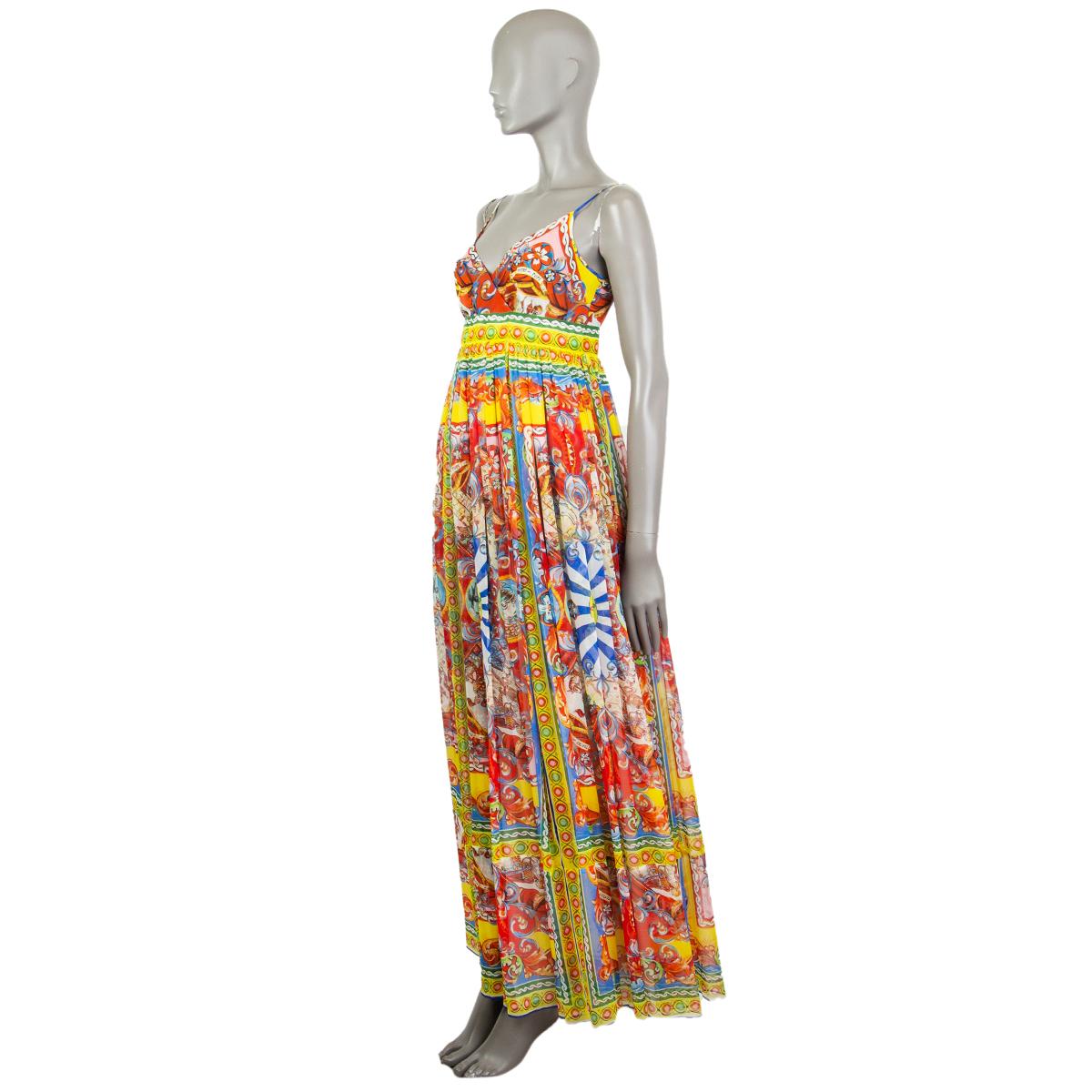 Dolce & Gabbana 'Teatro dei Pupi' maxi dress in red, royal blue, navy, yellow, black, white, green, baby pink, light blue silk (100%). With cross neck and spaghetti straps. Closes with hook and invisible zipper on the back. Lined in off-white silk