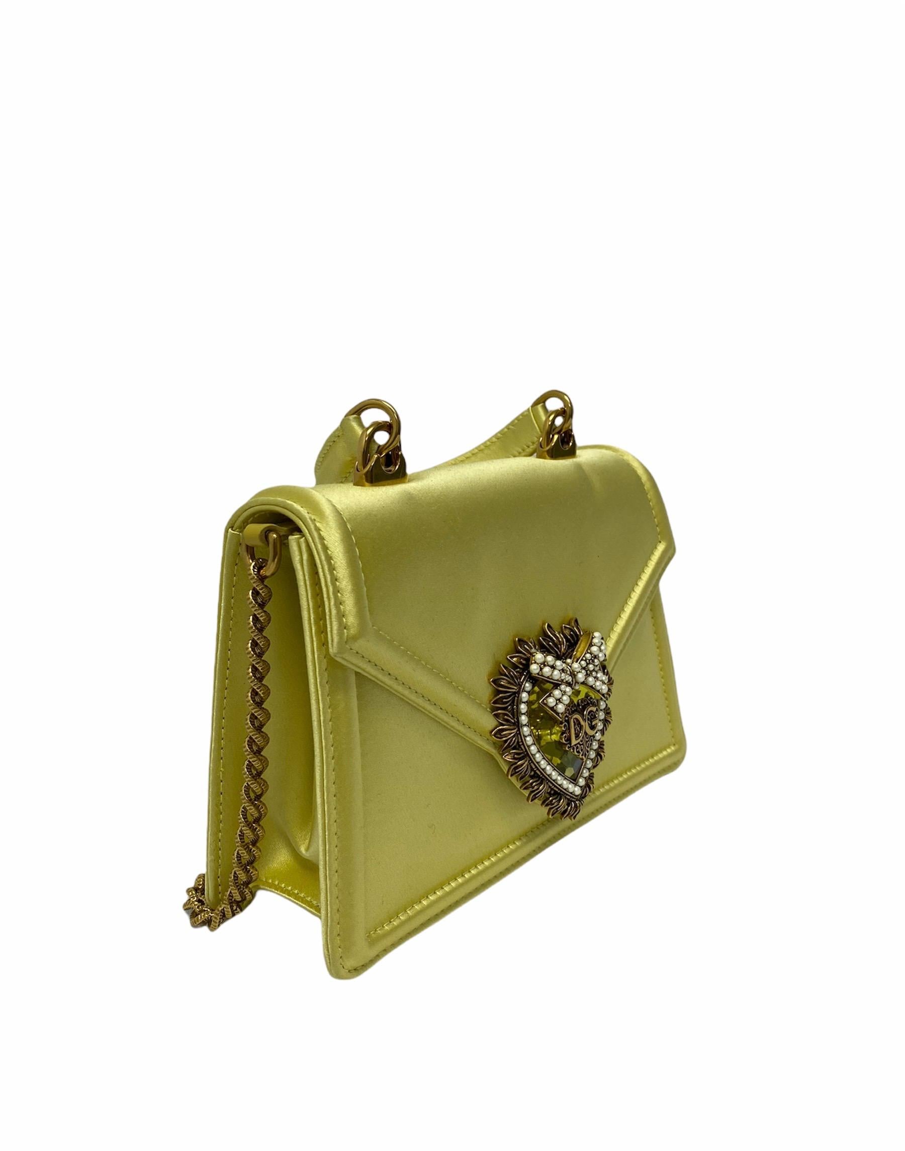Fantastic bag by Dolce & Gabbana Devotion line made of yellow satin with golden hardware, embellished with pearls and crystals. Button closure, internally roomy for the essentials. Equipped with a top handle and chain shoulder strap, to wear it as