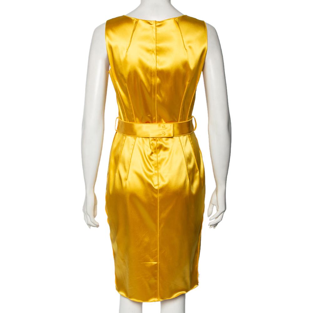 This gorgeous dress from the House of Dolce & Gabbana adds a refreshing antidote to your summer wardrobe. It has been tailored lavishly using yellow satin fabric and features a sleeveless style, zip closure, and a belted detail. Splendid and